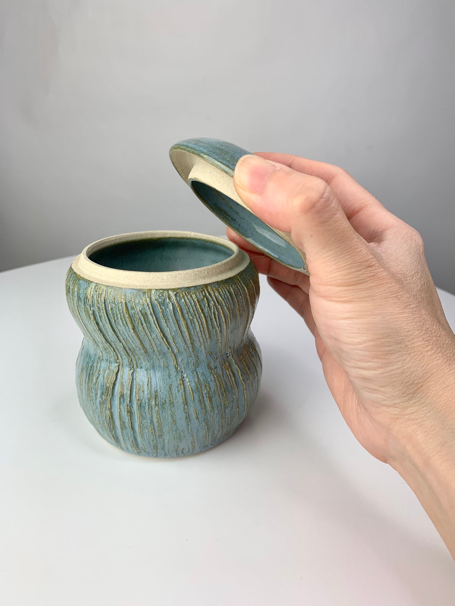 Multi-functional ceramic jar with carvings