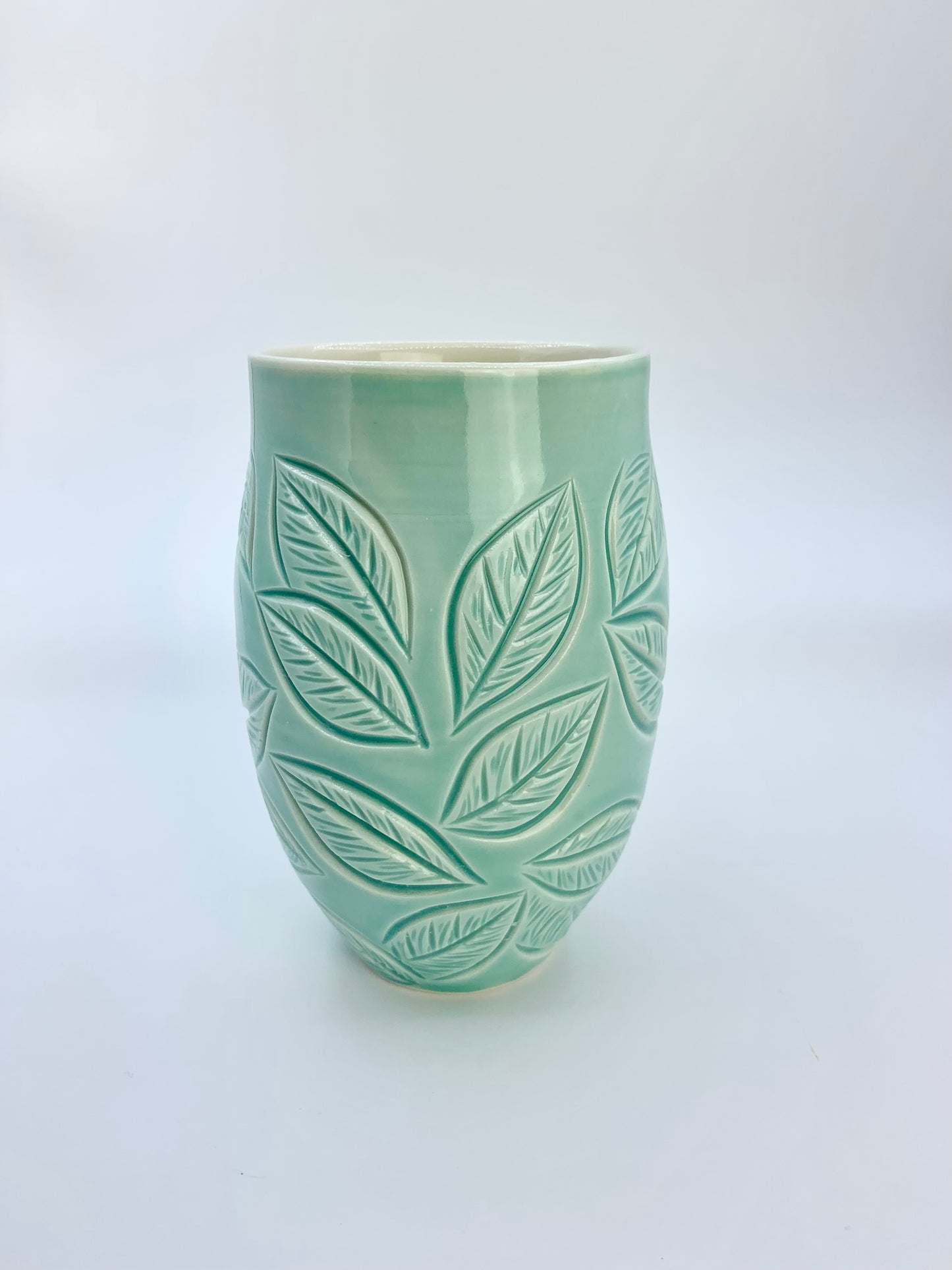 Large porcelain mug with leaf carvings in turquoise
