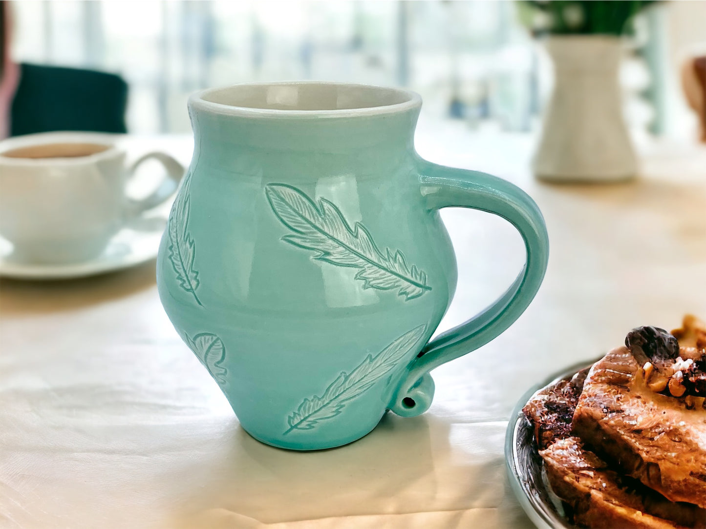 12 oz porcelain mug with feather carvings in turquoise