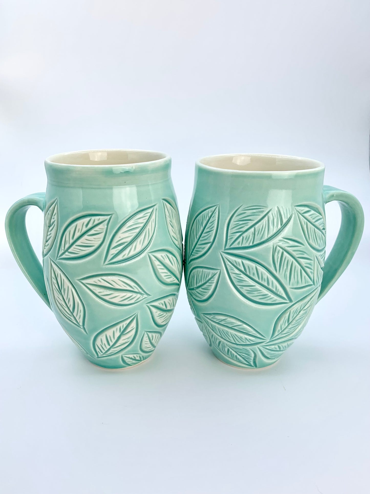 Large porcelain mug with leaf carvings in turquoise
