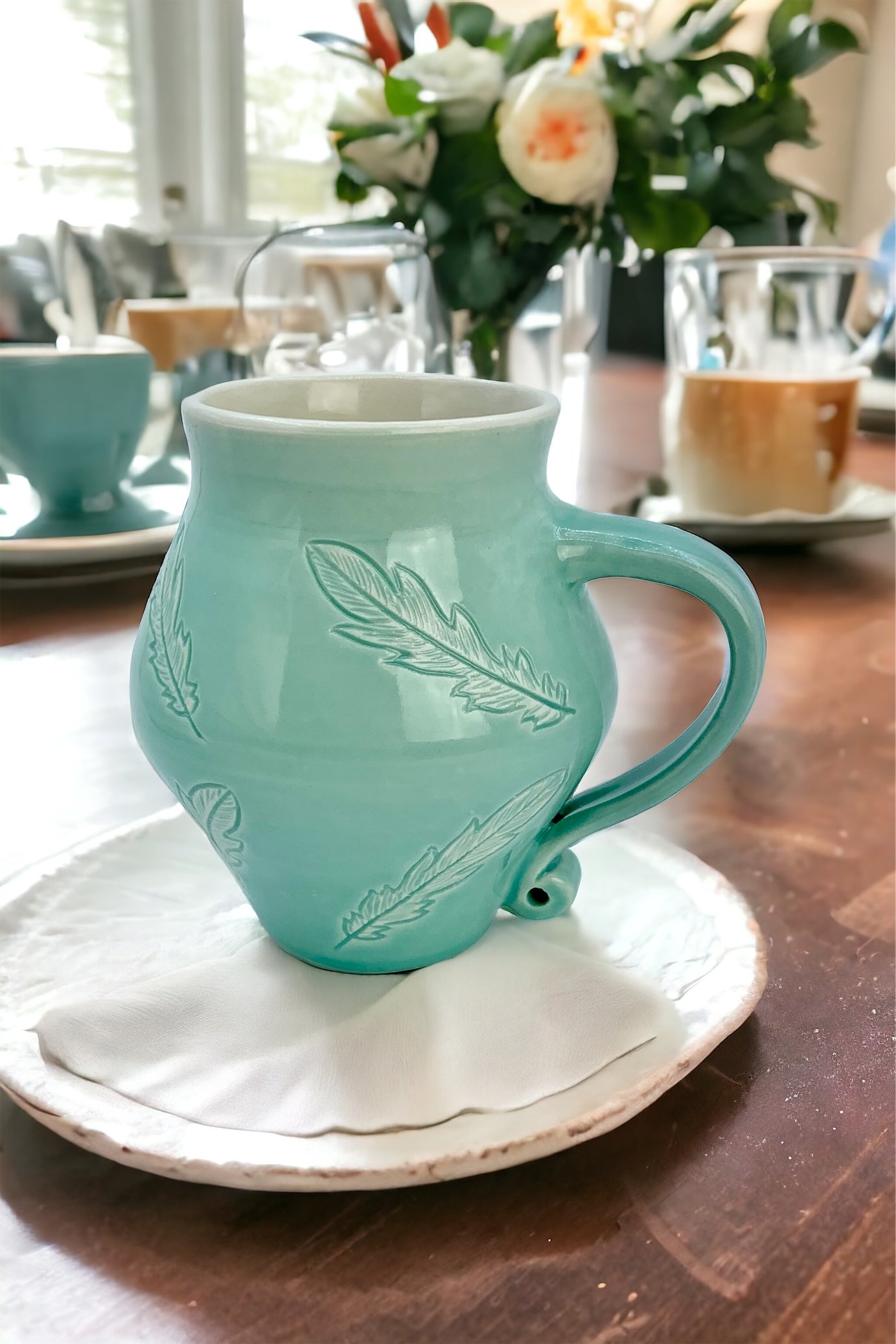 12 oz porcelain mug with feather carvings in turquoise