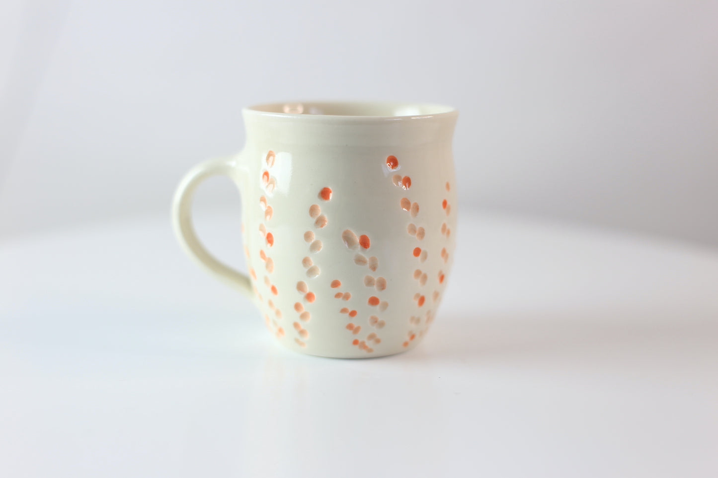 Porcelain mug with abstract floral carvings