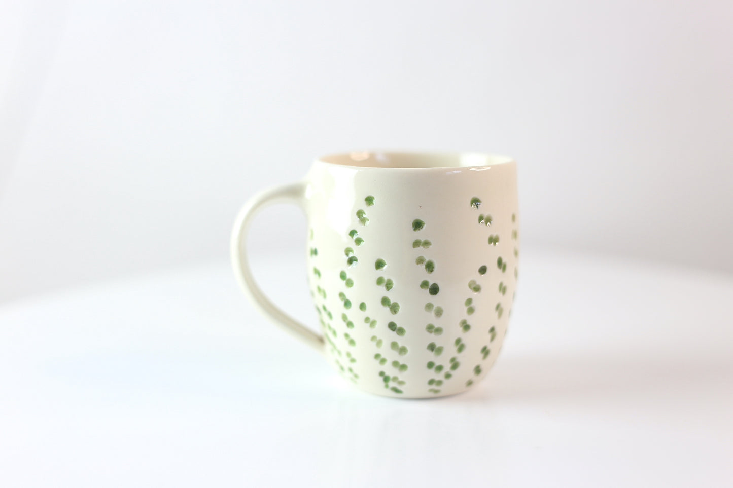 Porcelain mug with abstract floral carvings
