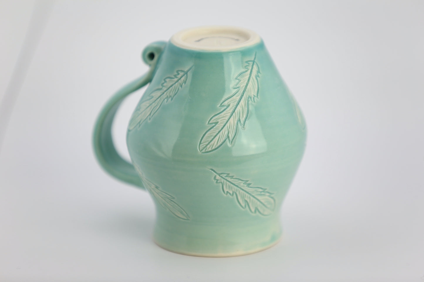 12 oz porcelain mug with feather carvings in turquoise