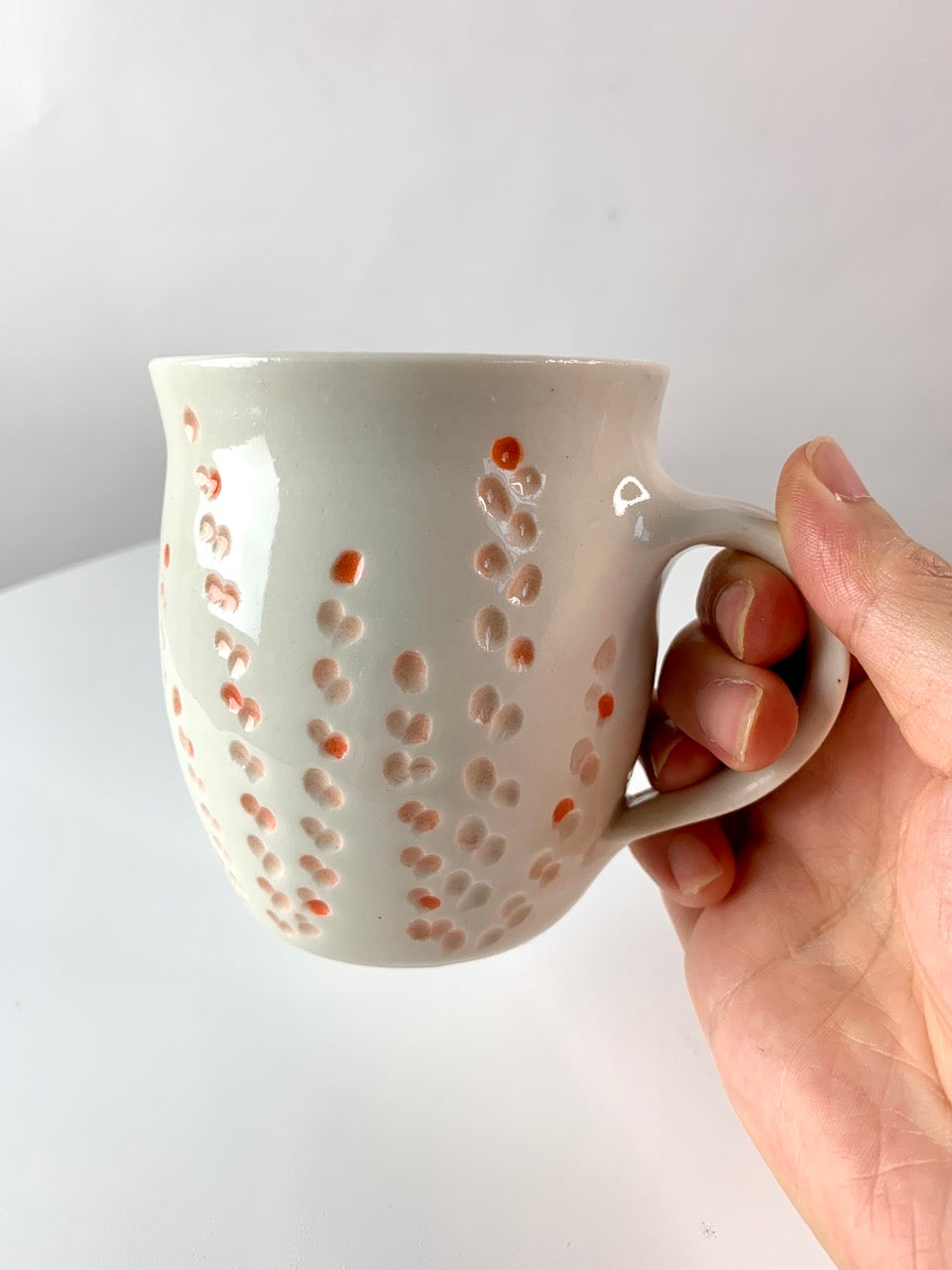 Porcelain mug with abstract floral carvings
