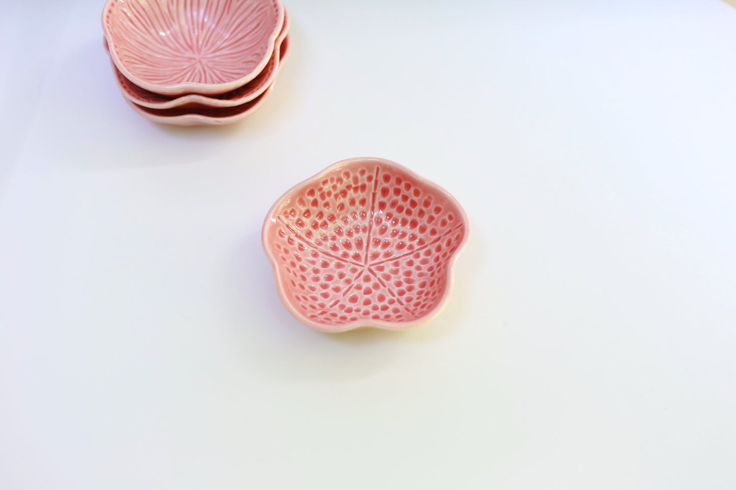 Small porcelain bowl with carvings in coral color