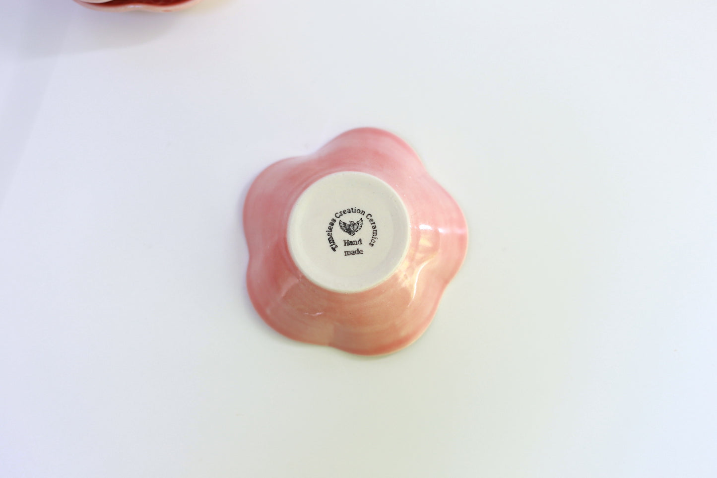 Small porcelain bowl with carvings in coral color