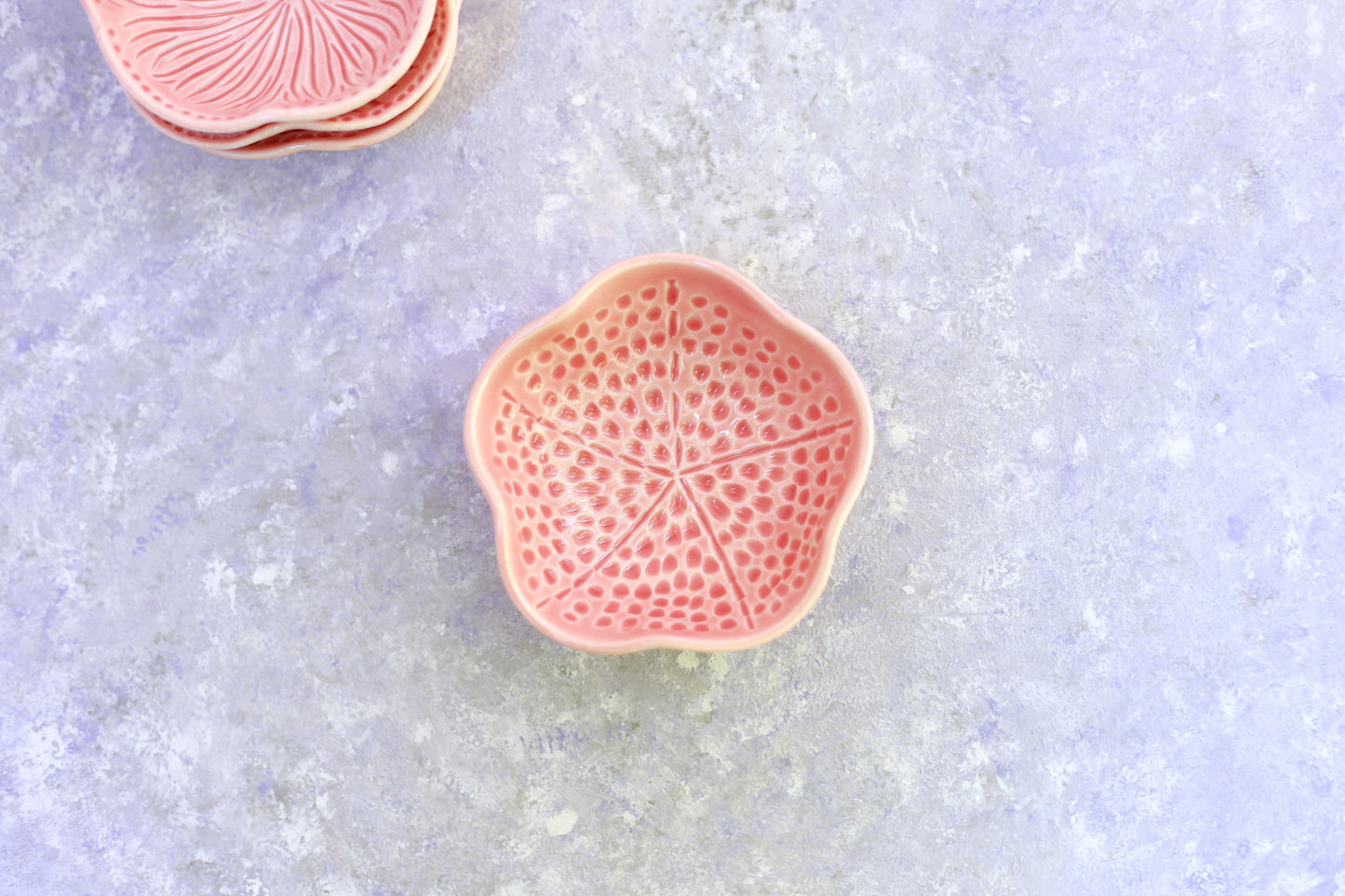 Small porcelain bowl with carvings in coral color