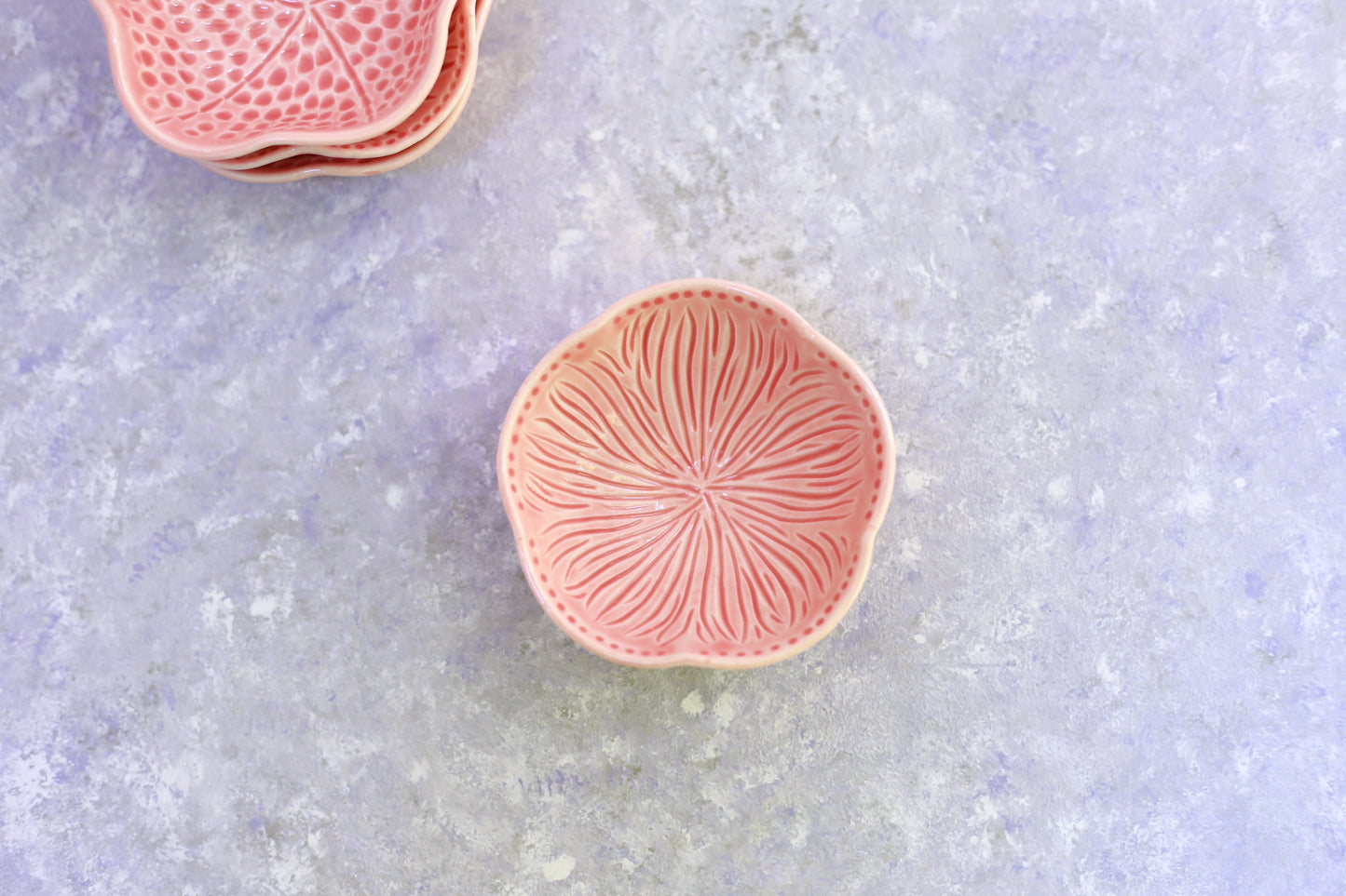 Small porcelain bowl with carvings in coral color