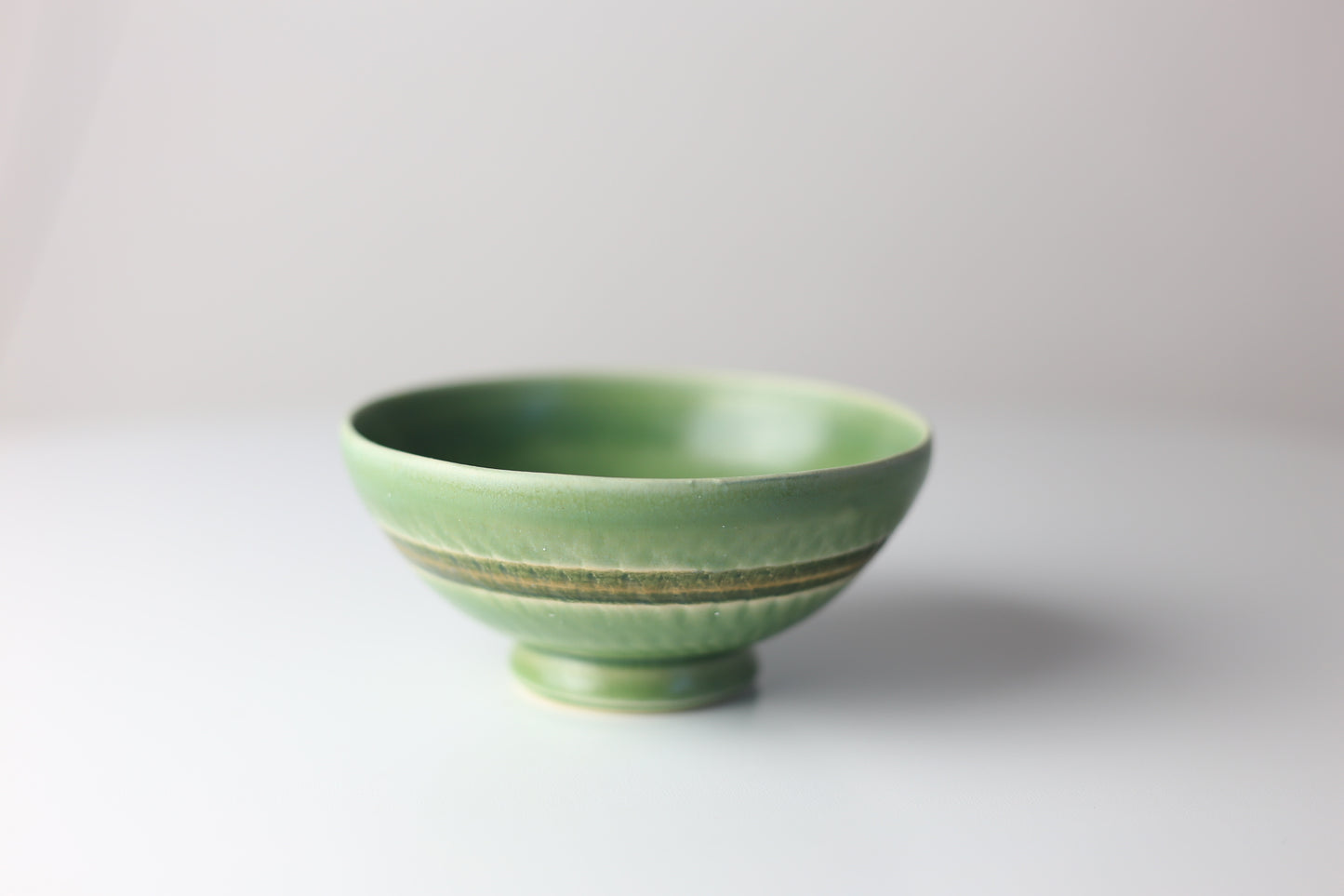 Small green stoneware bowl with chattering design #50