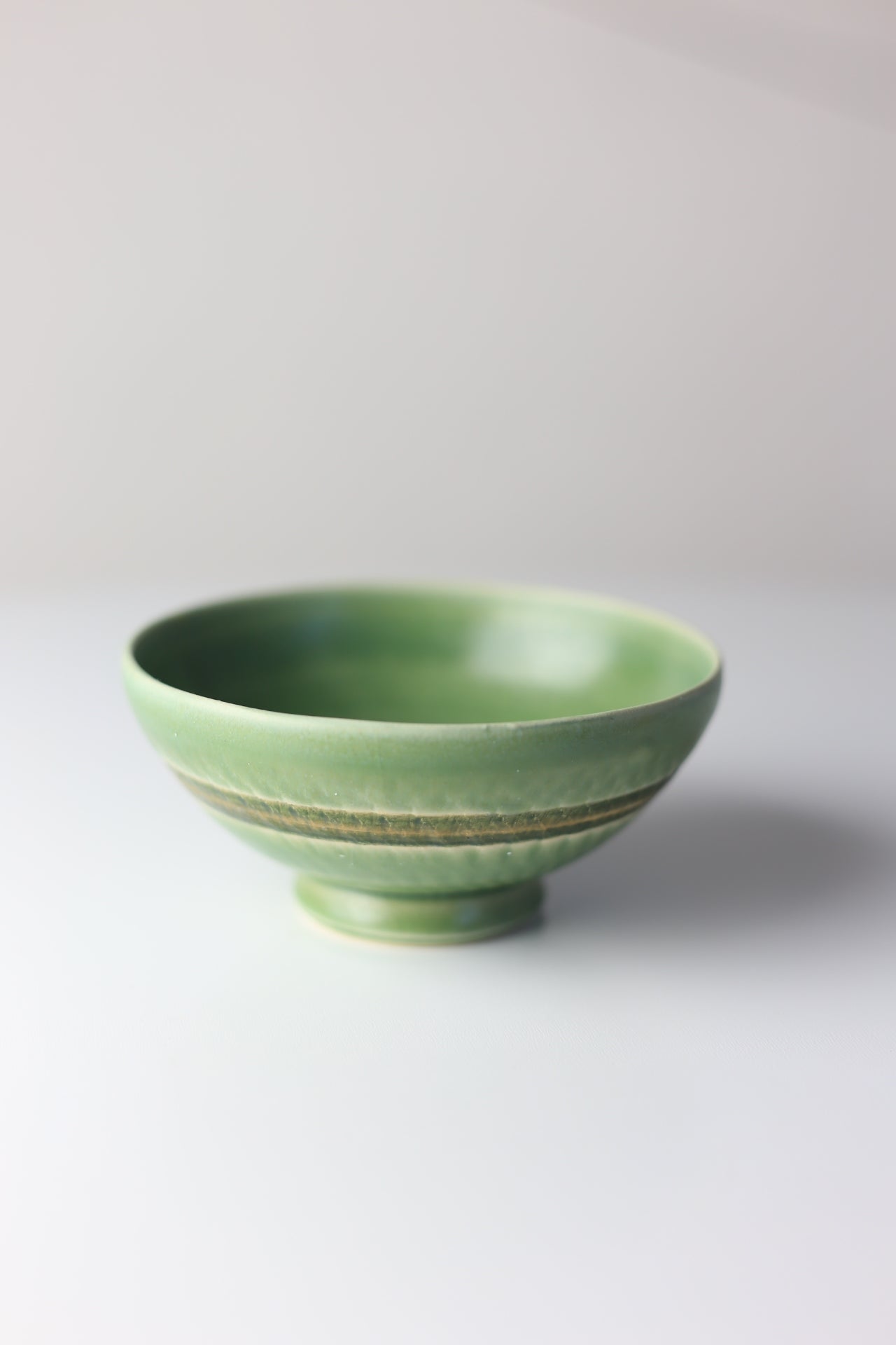 Small green stoneware bowl with chattering design #50