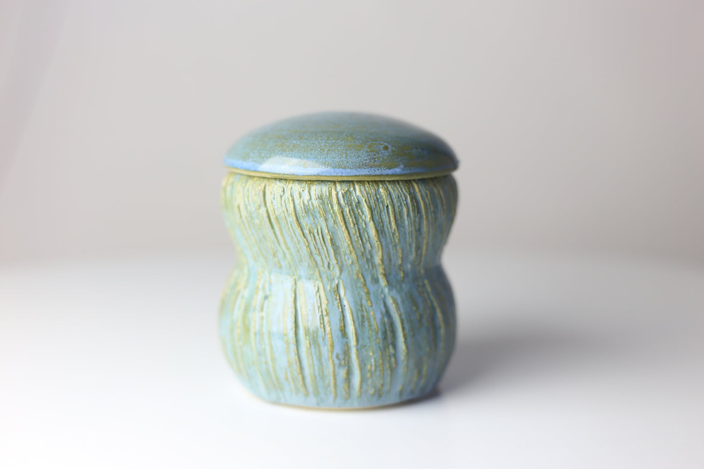 Multi-functional ceramic jar with carvings