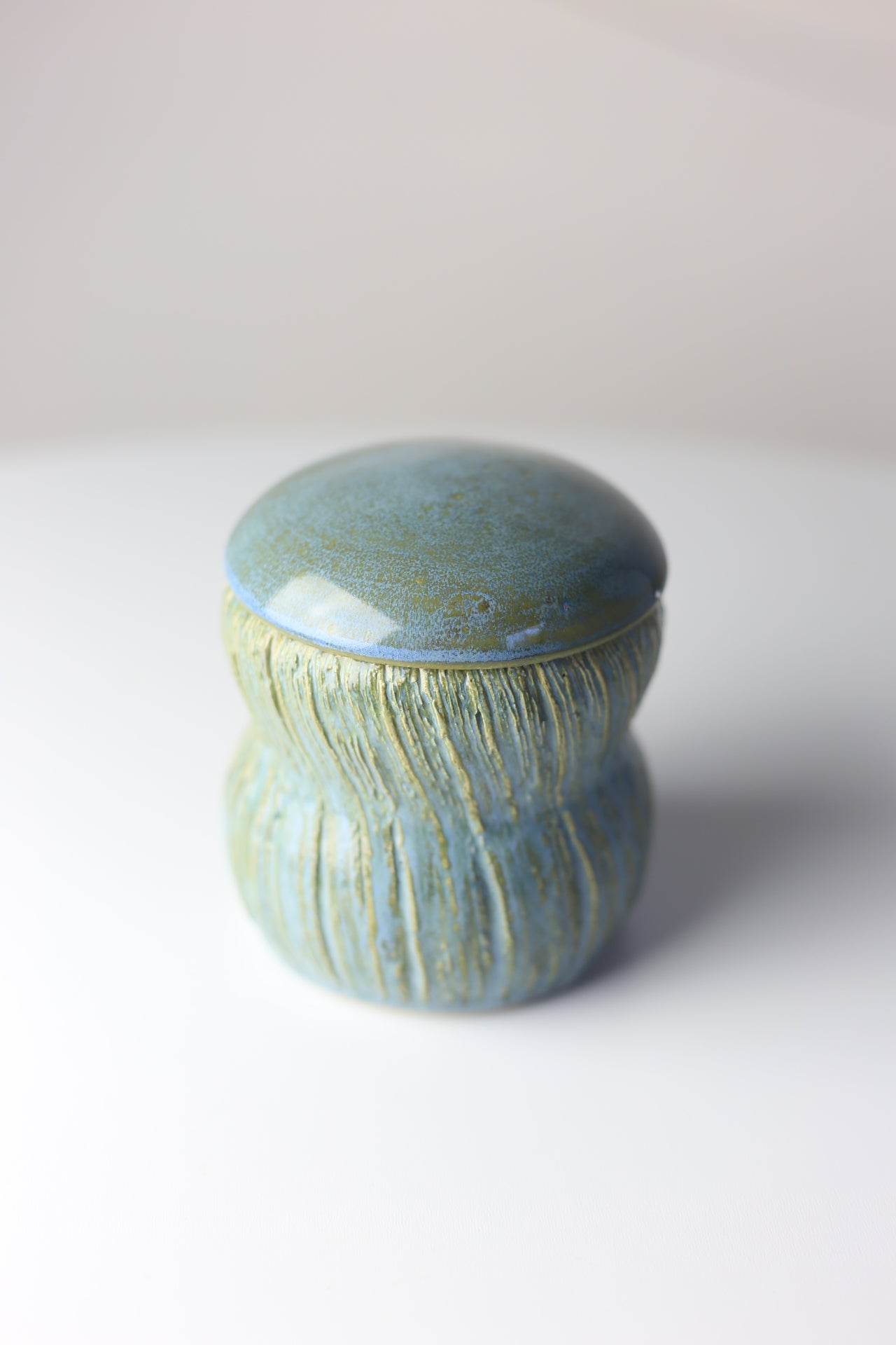 Multi-functional ceramic jar with carvings