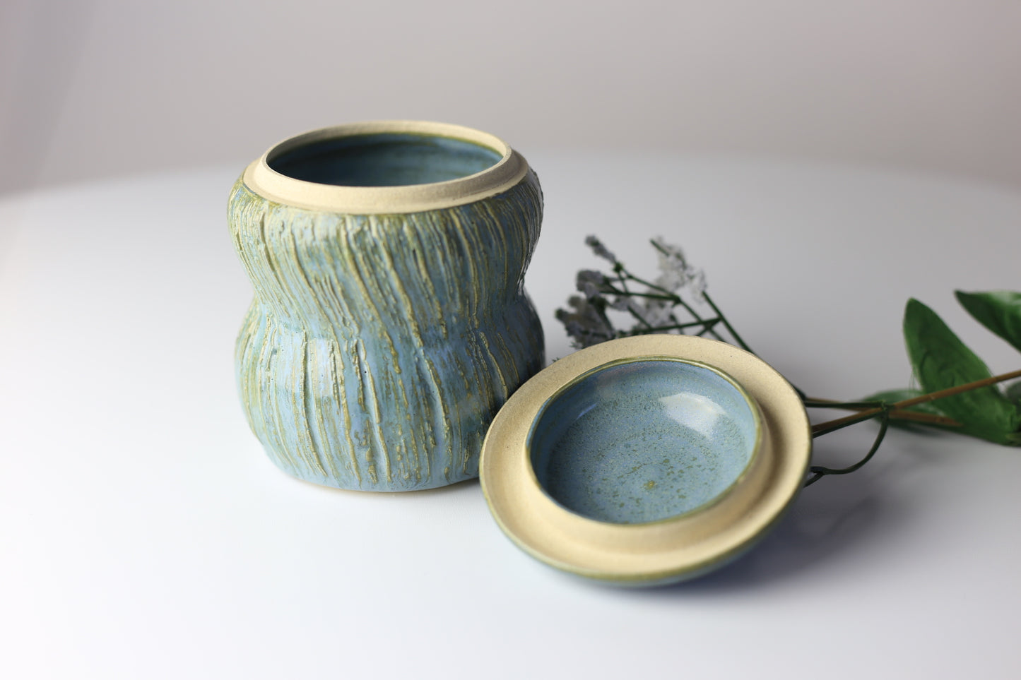 Multi-functional ceramic jar with carvings