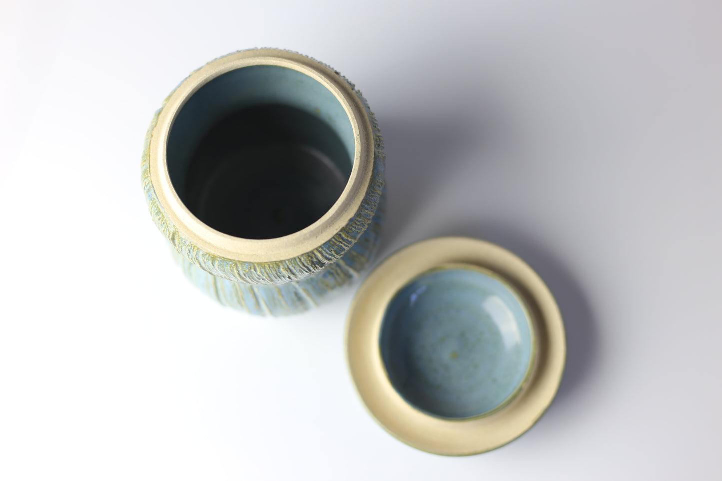Multi-functional ceramic jar with carvings