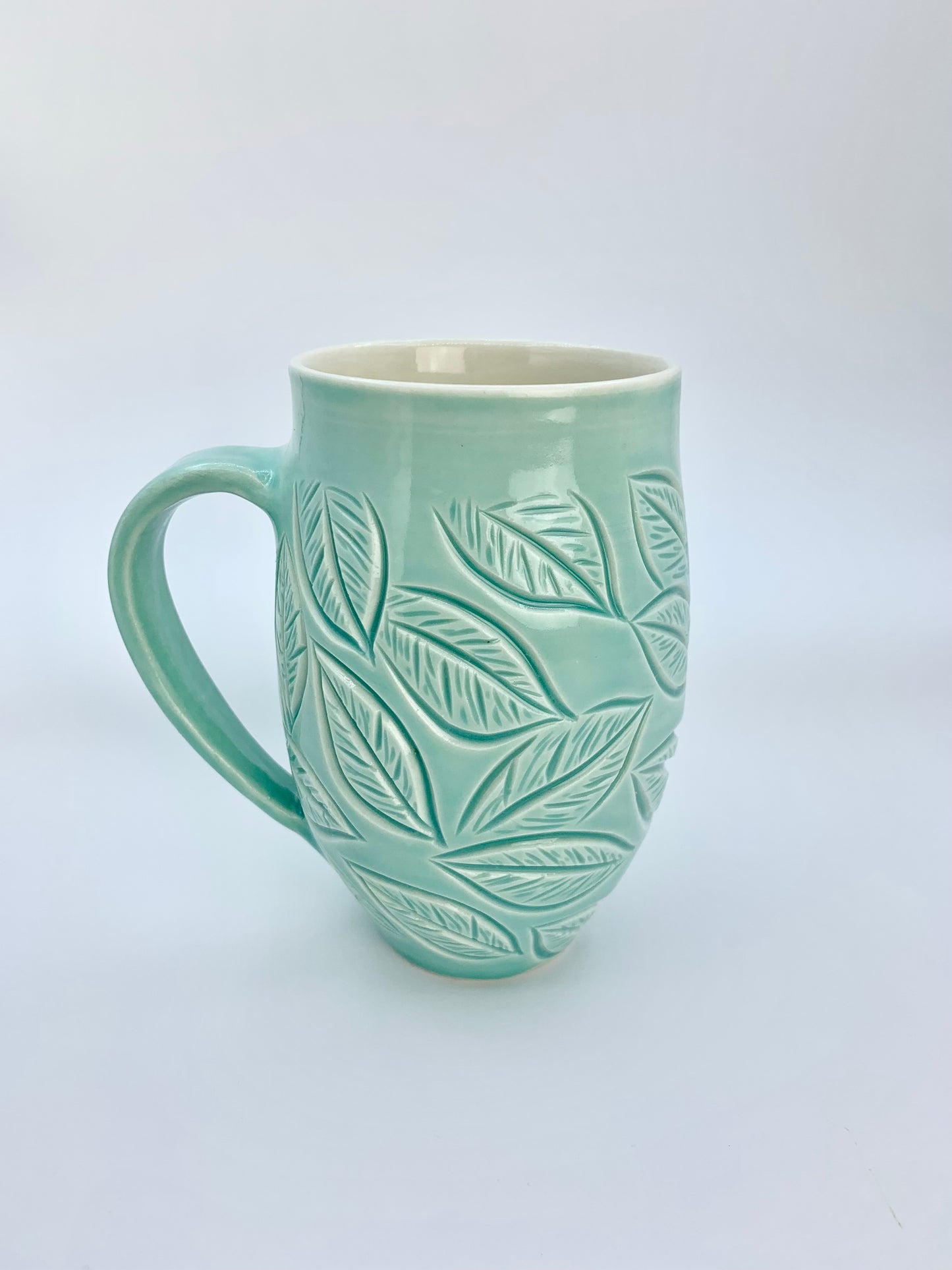 Large porcelain mug with leaf carvings in turquoise