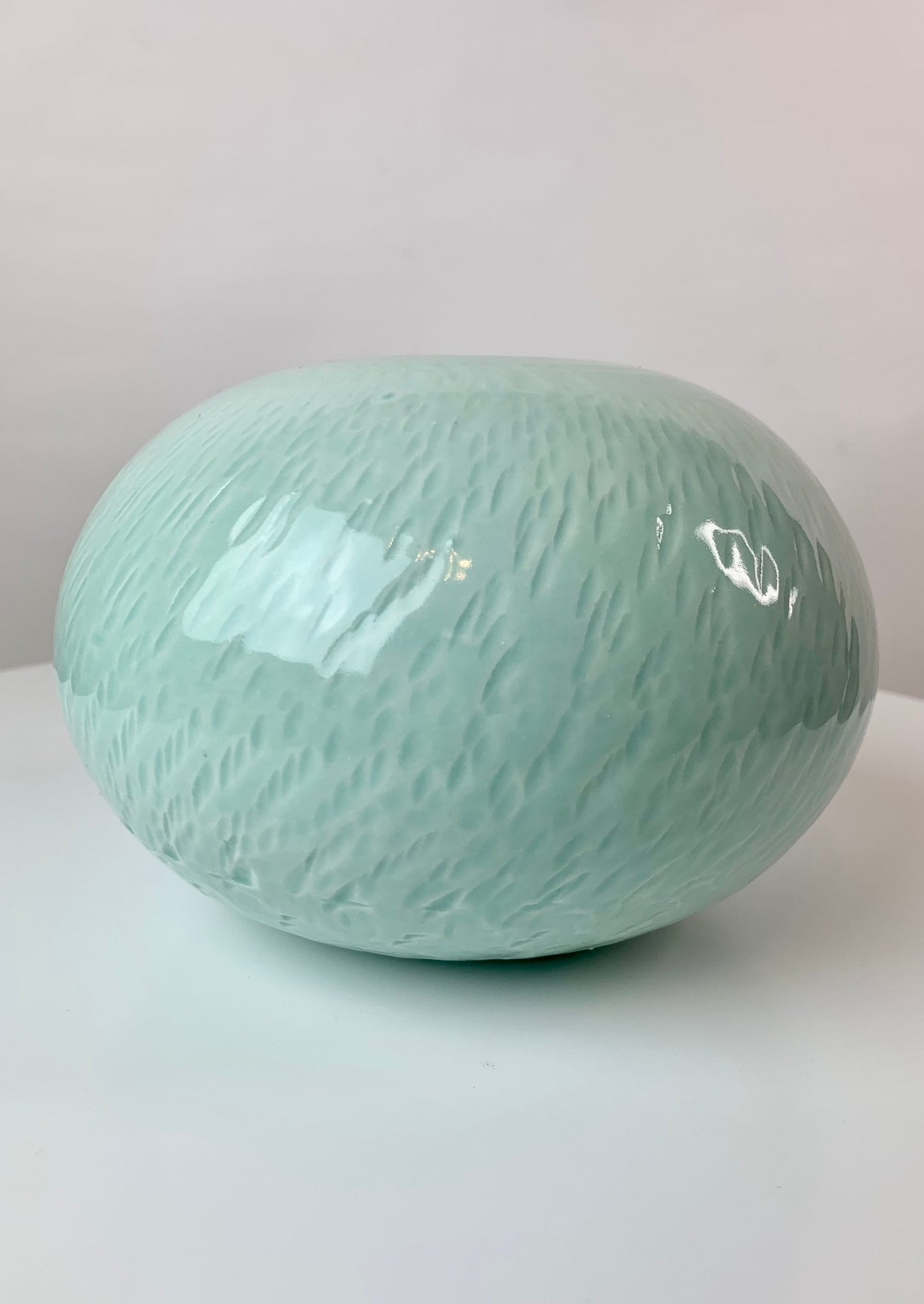 Bulbous round porcelain vase with texture in turquoise