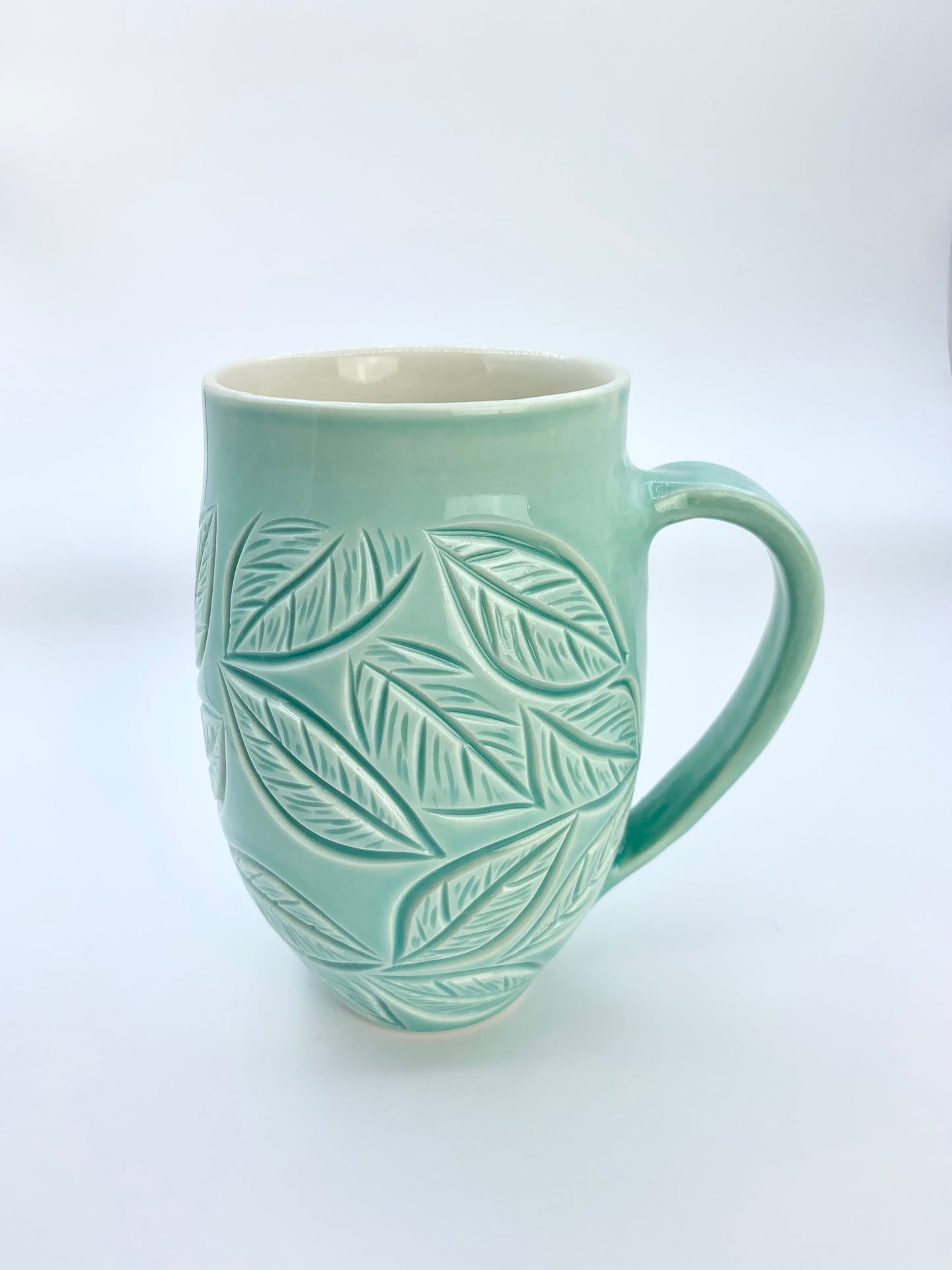Large porcelain mug with leaf carvings in turquoise