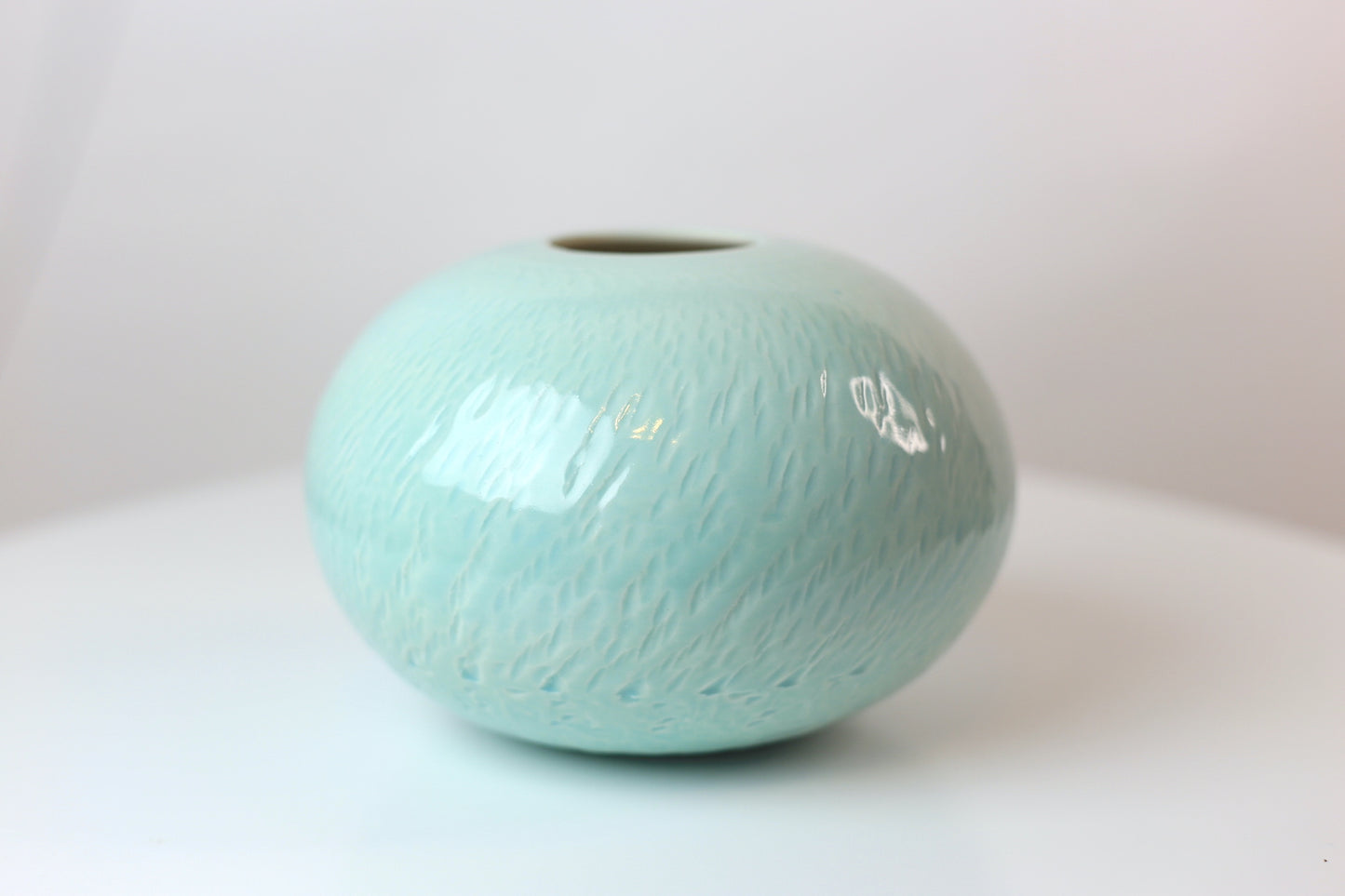 Bulbous round porcelain vase with texture in turquoise