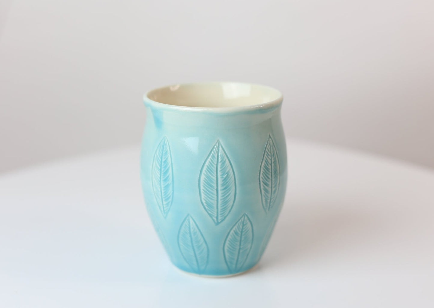 12 oz porcelain mug with carved leaves in turquoise