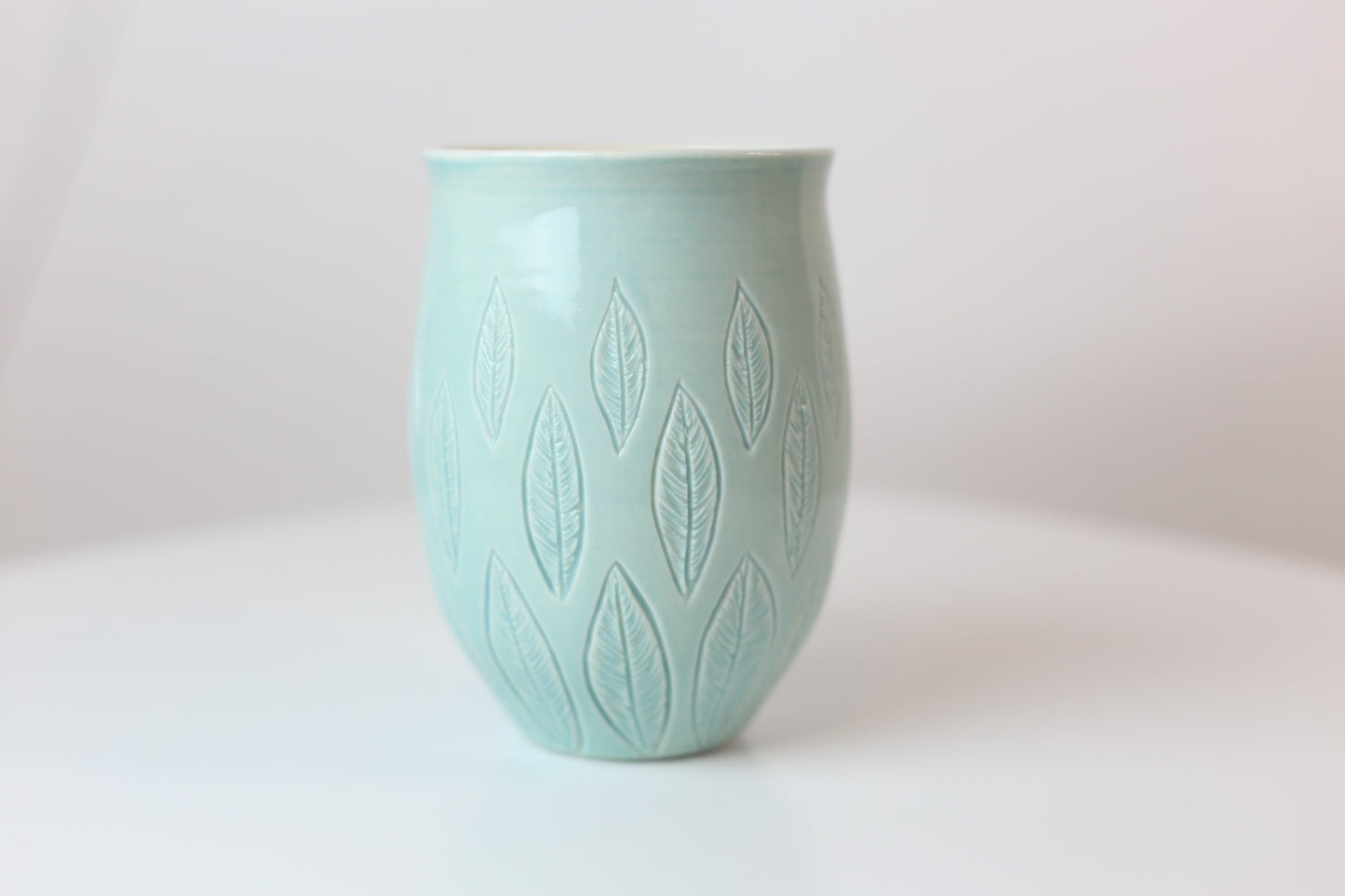 Large porcelain mug with leaf design in turquoise