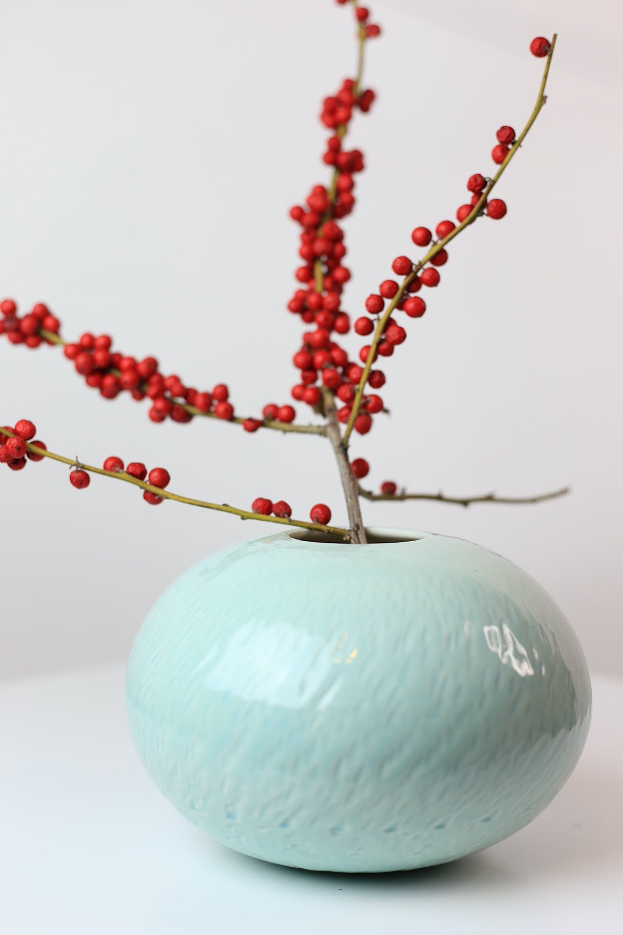 Bulbous round porcelain vase with texture in turquoise
