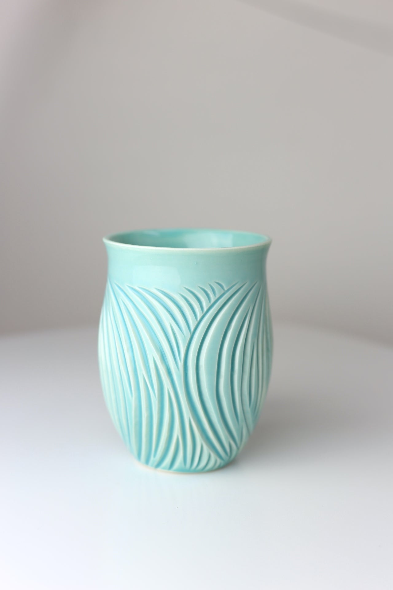 Large porcelain mug with abstract carvings in turquoise