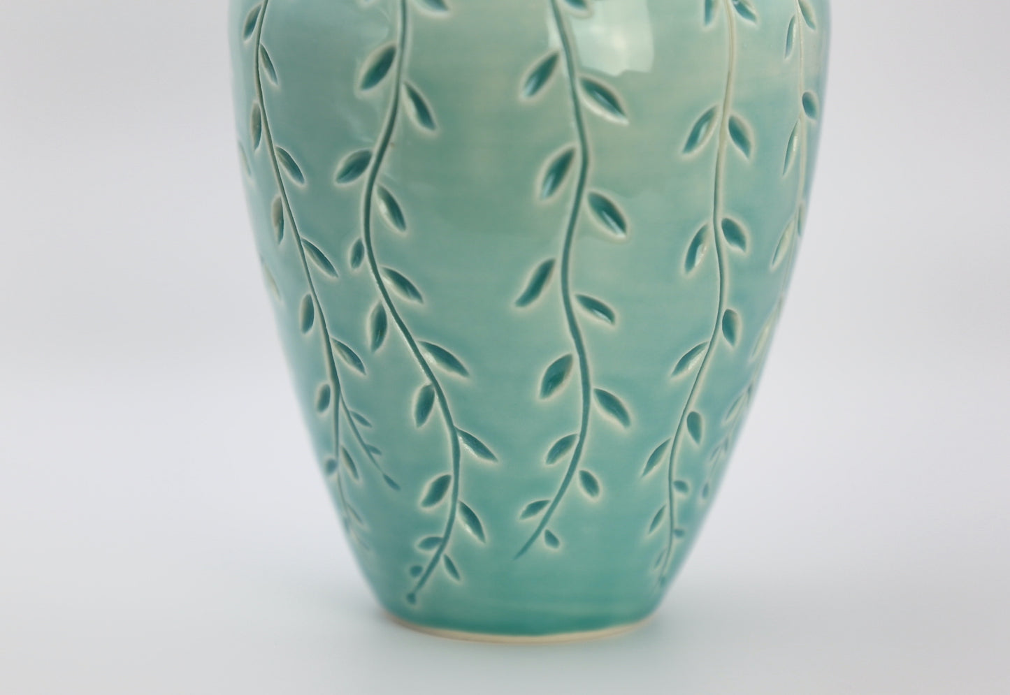 Porcelain vase with vine carvings in turquoise