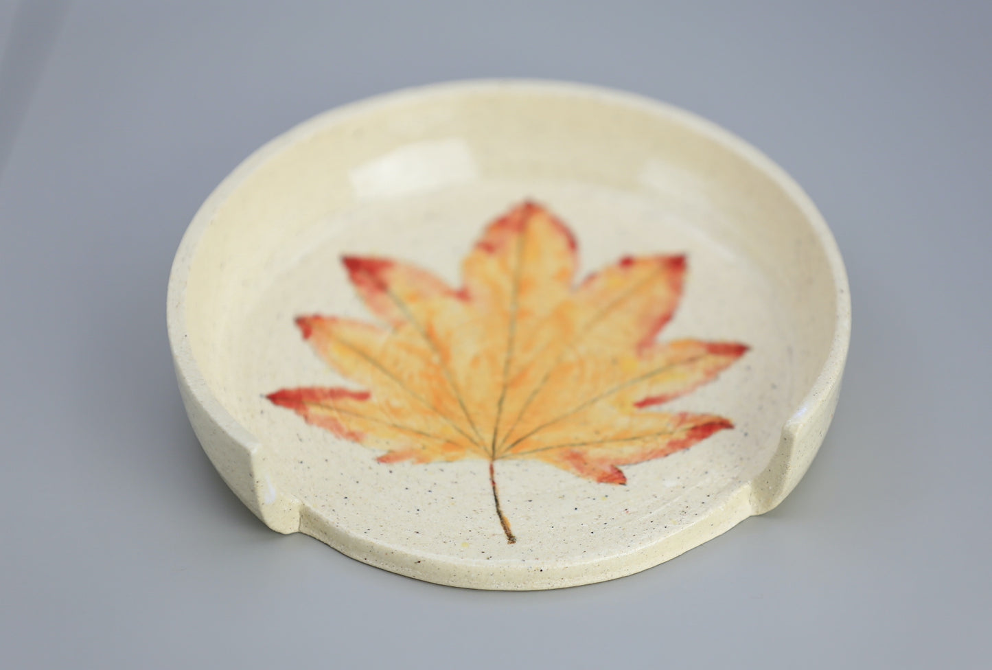 Ceramic spoon rest with handpainted leaf motif