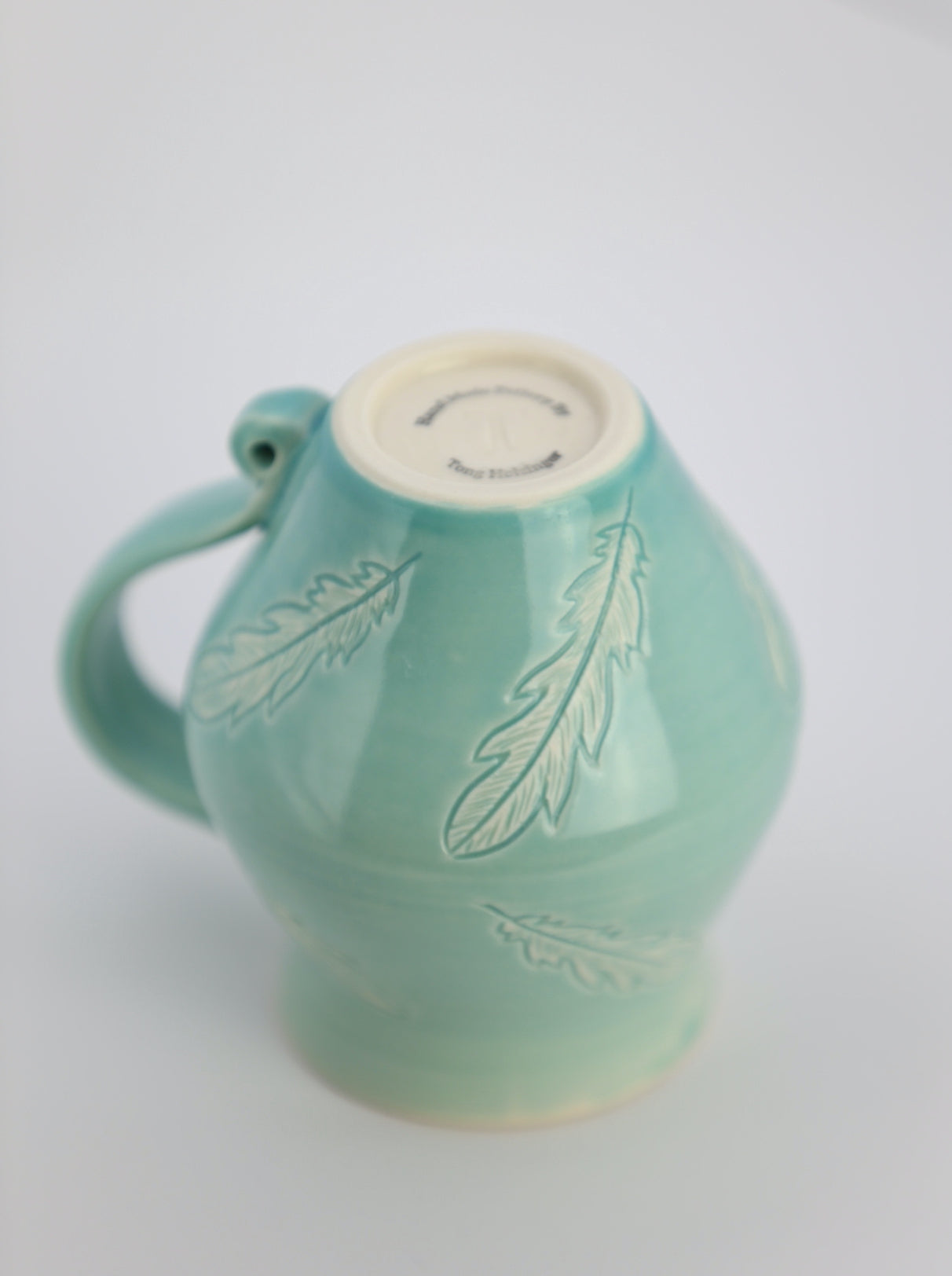 12 oz porcelain mug with feather carvings in turquoise