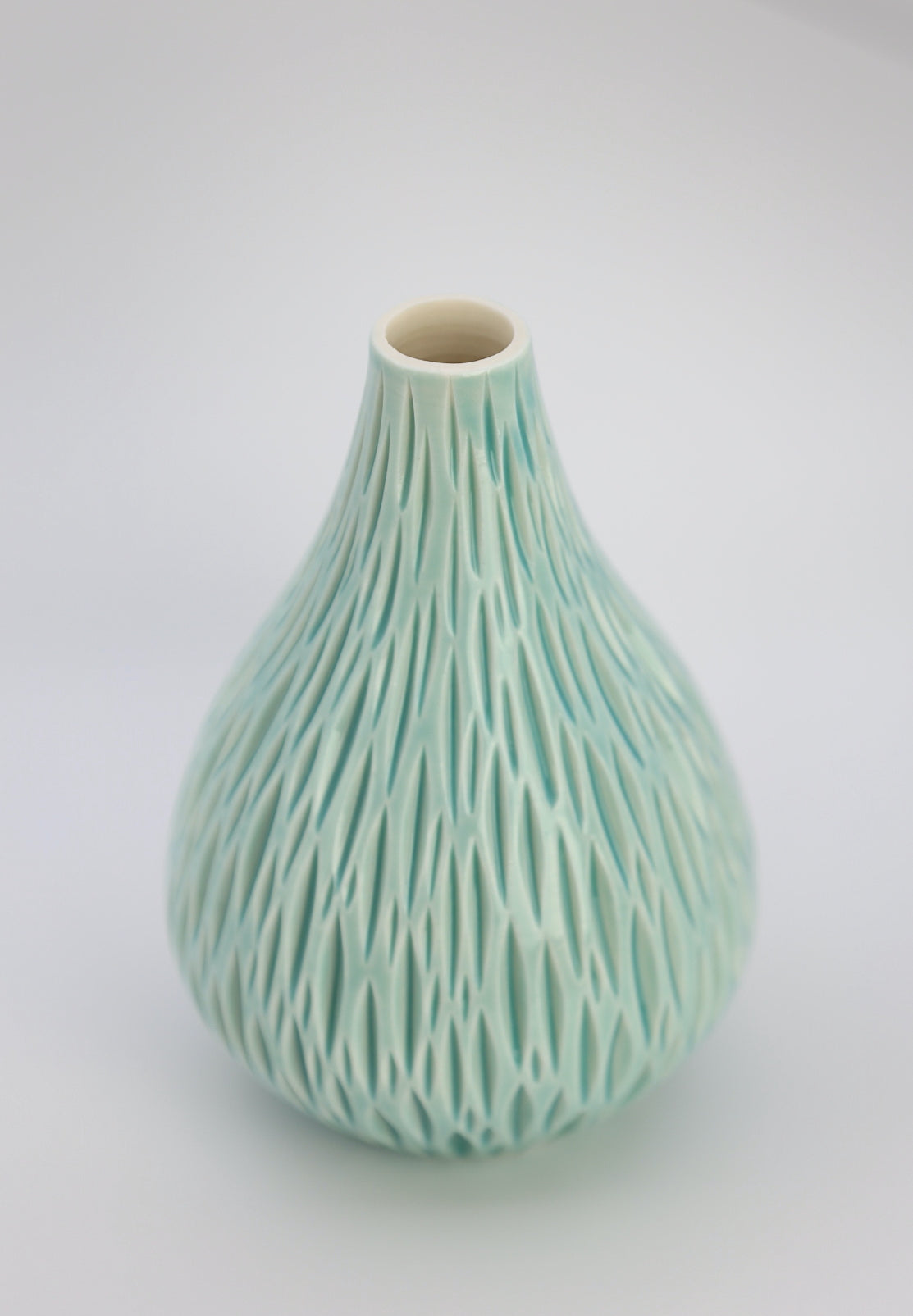 Porcelain bud vase with geometric carvings in turquoise