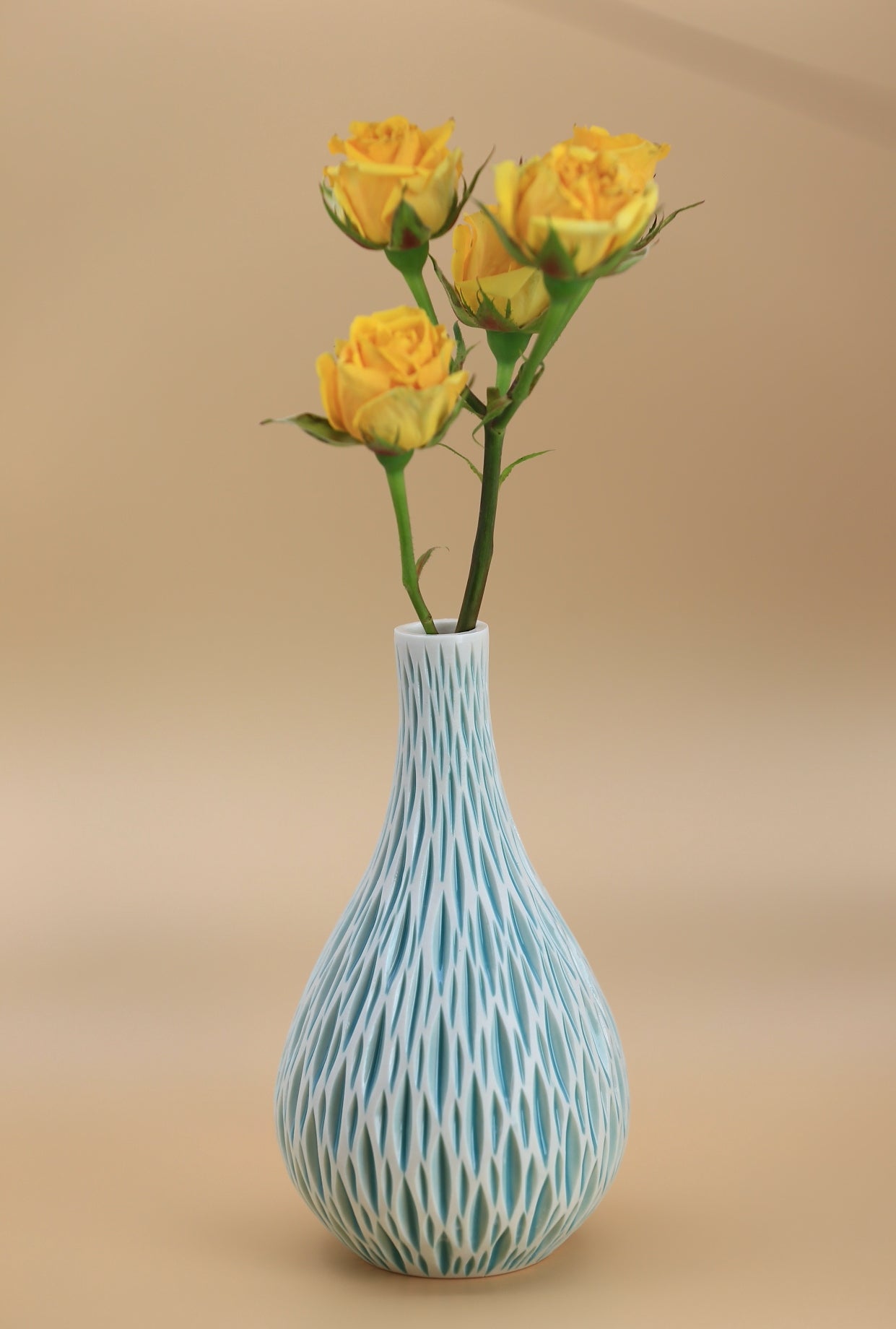 Tall porcelain bud vase with geometric carvings in turquoise white