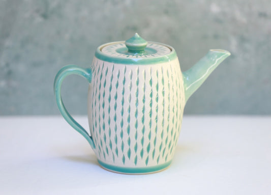 Porcelain teapot with carvings in turquoise