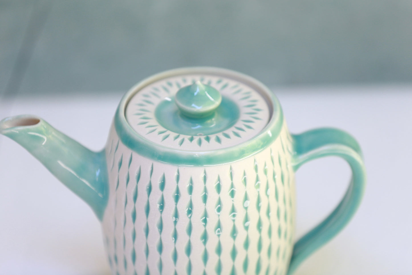 Porcelain teapot with carvings in turquoise