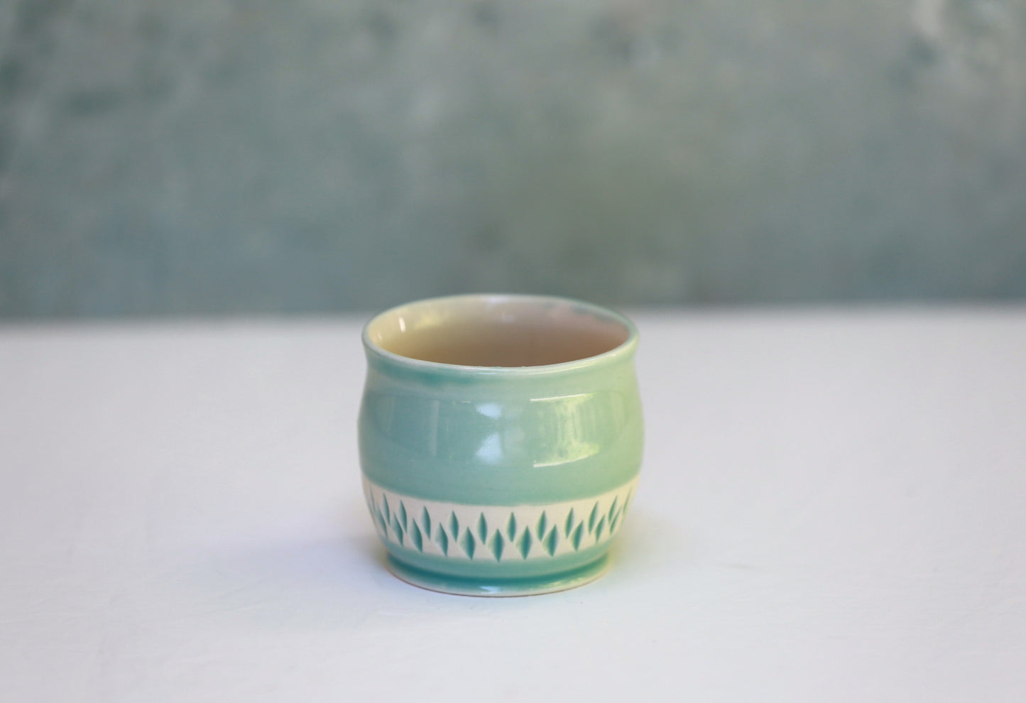 Porcelain teacup with carvings in turquoise