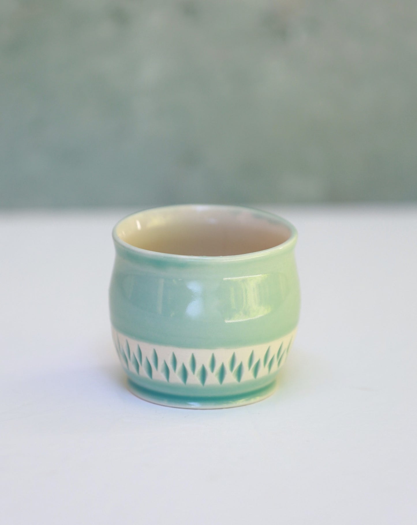 Porcelain teacup with carvings in turquoise