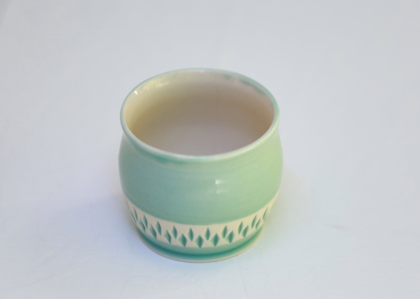 Porcelain teacup with carvings in turquoise