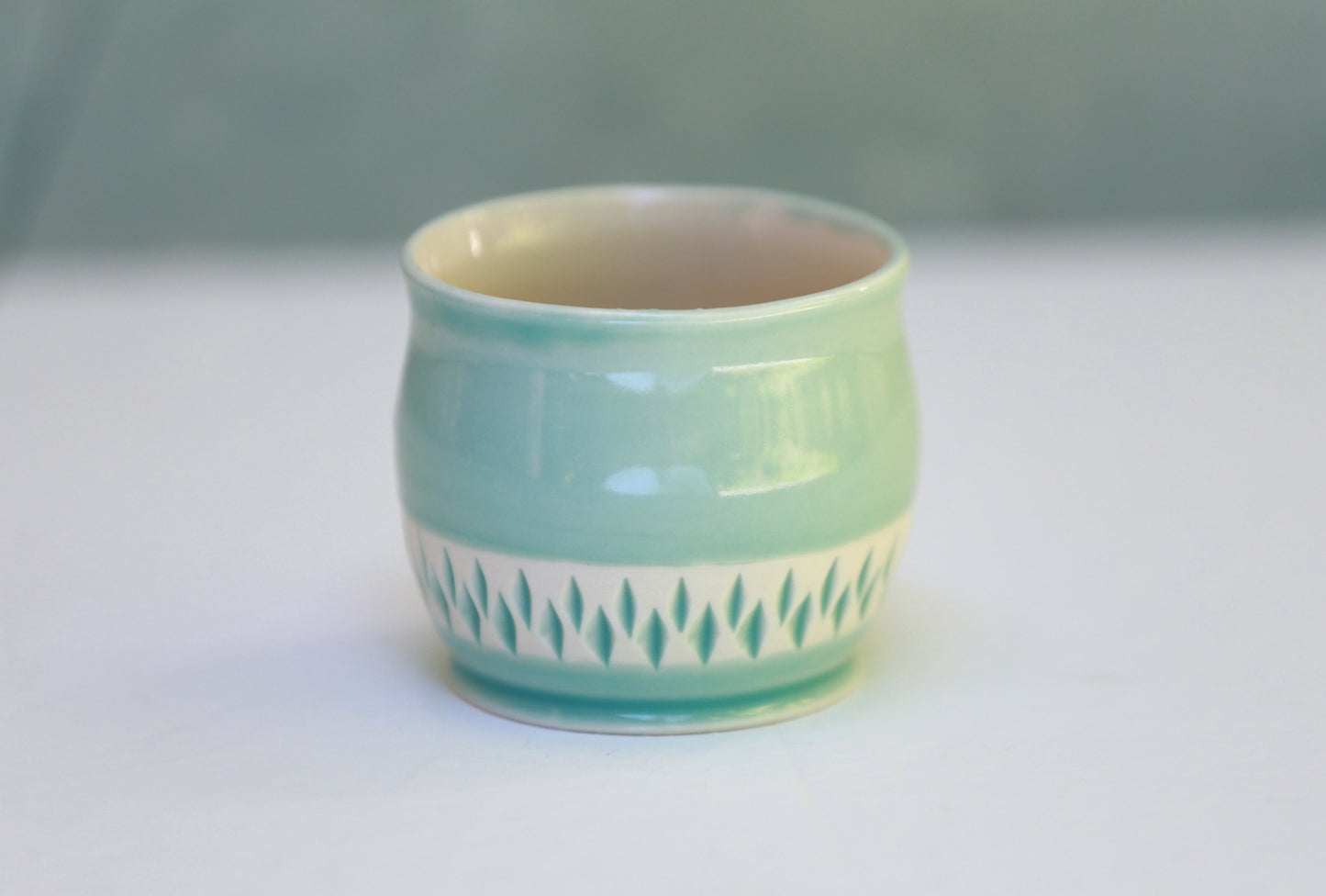 Porcelain teacup with carvings in turquoise