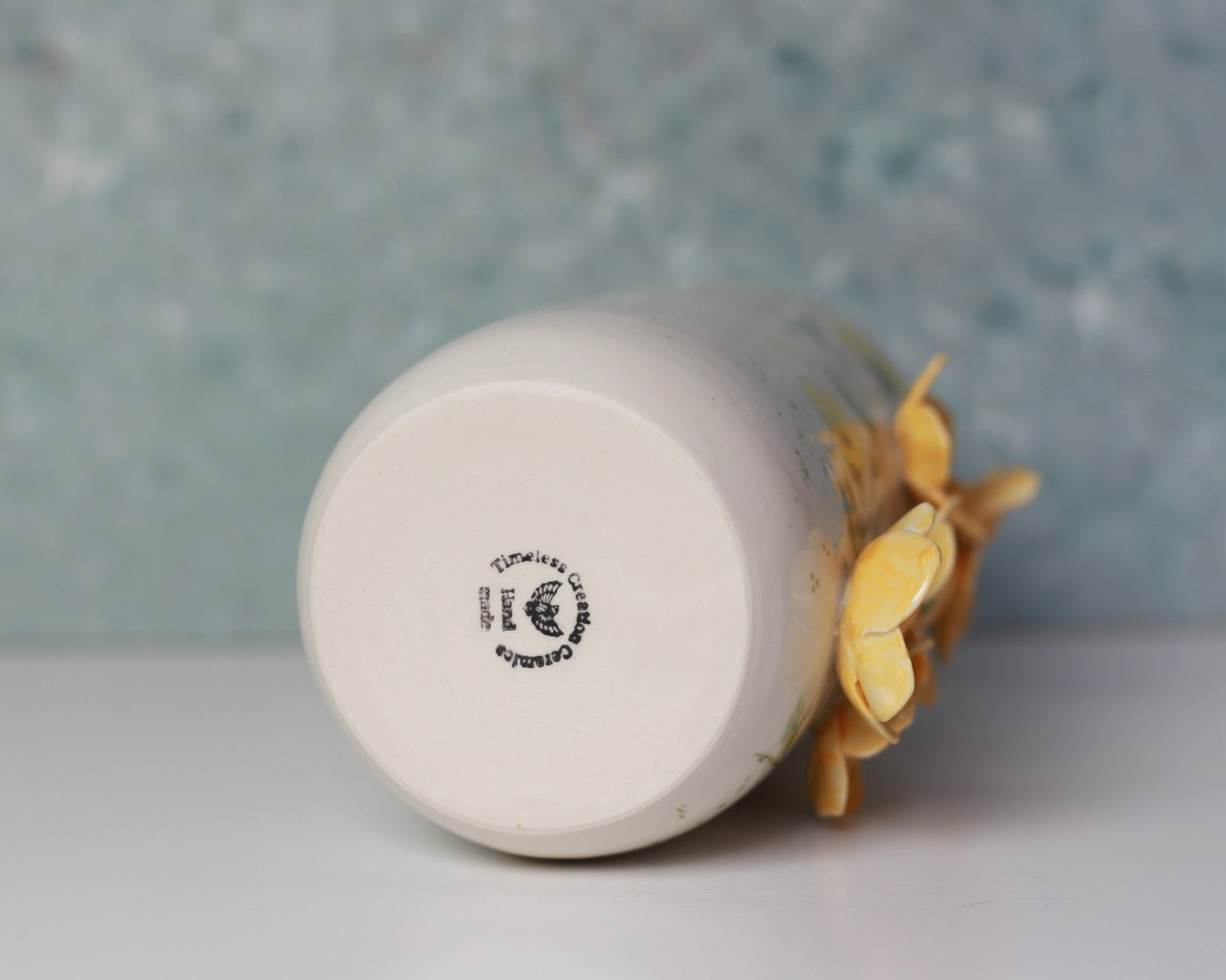 Ceramic mug with a brand logo on a neutral background