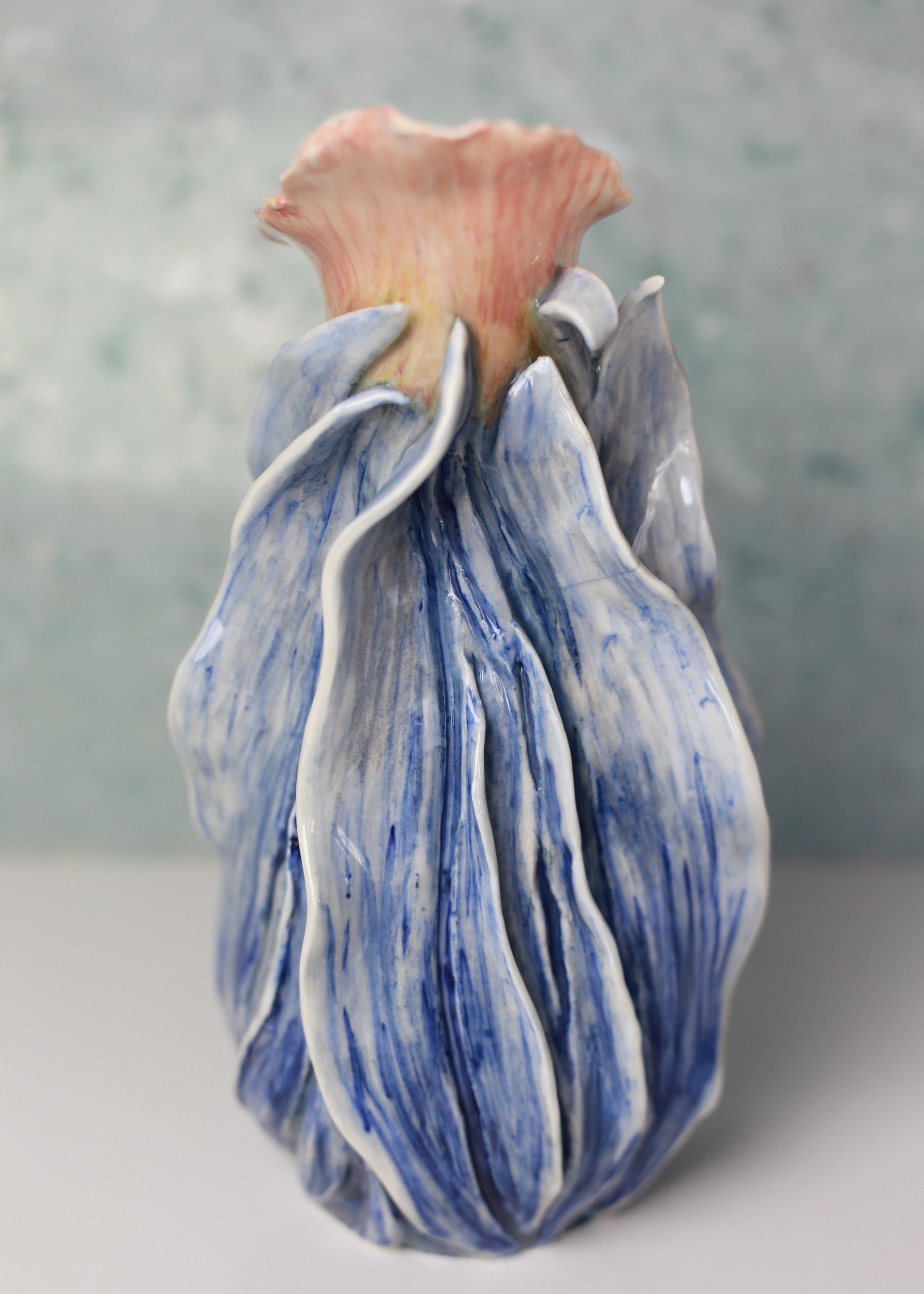 Blue and white ceramic flower on a gray background