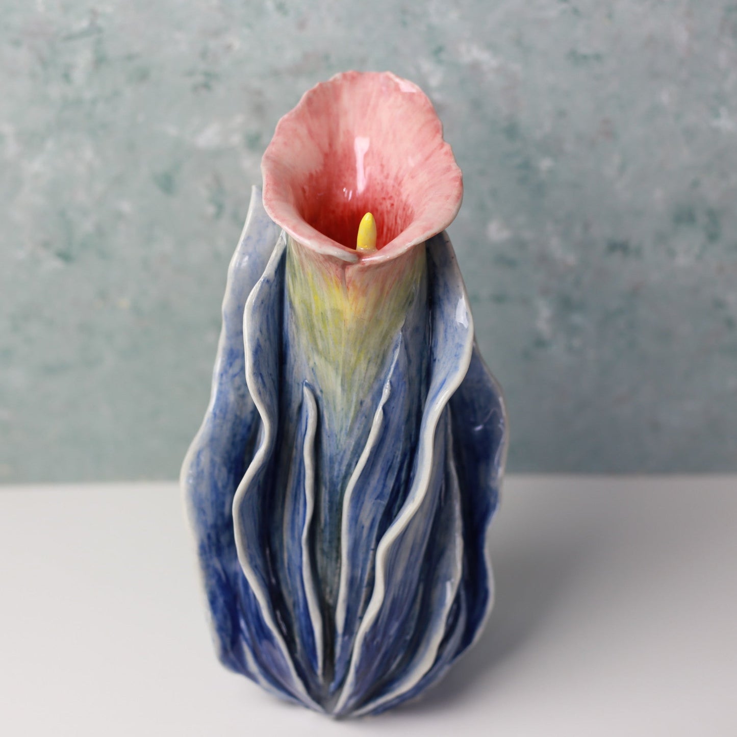 Ceramic vase with a floral design on a gray background