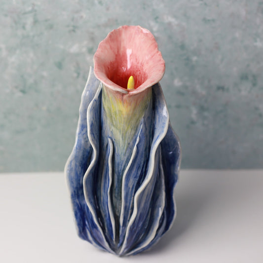 Ceramic vase with a floral design on a gray background