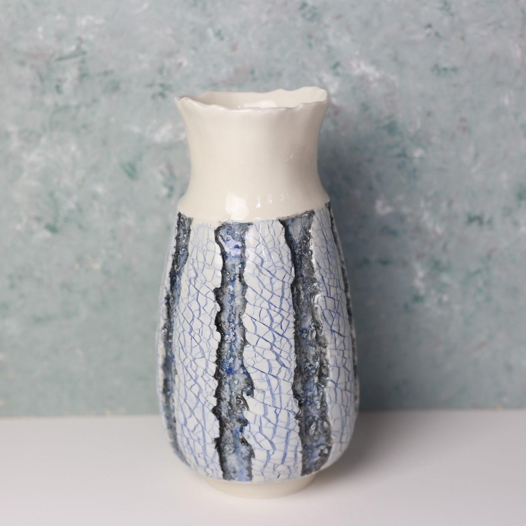 Ceramic vase with textured design on a gray background