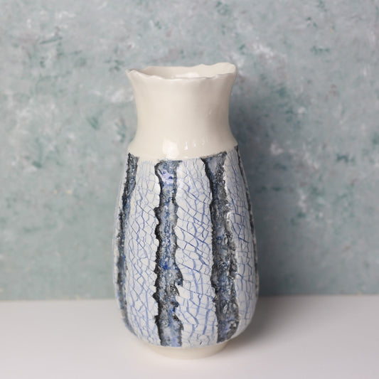 Ceramic vase with textured design on a gray background