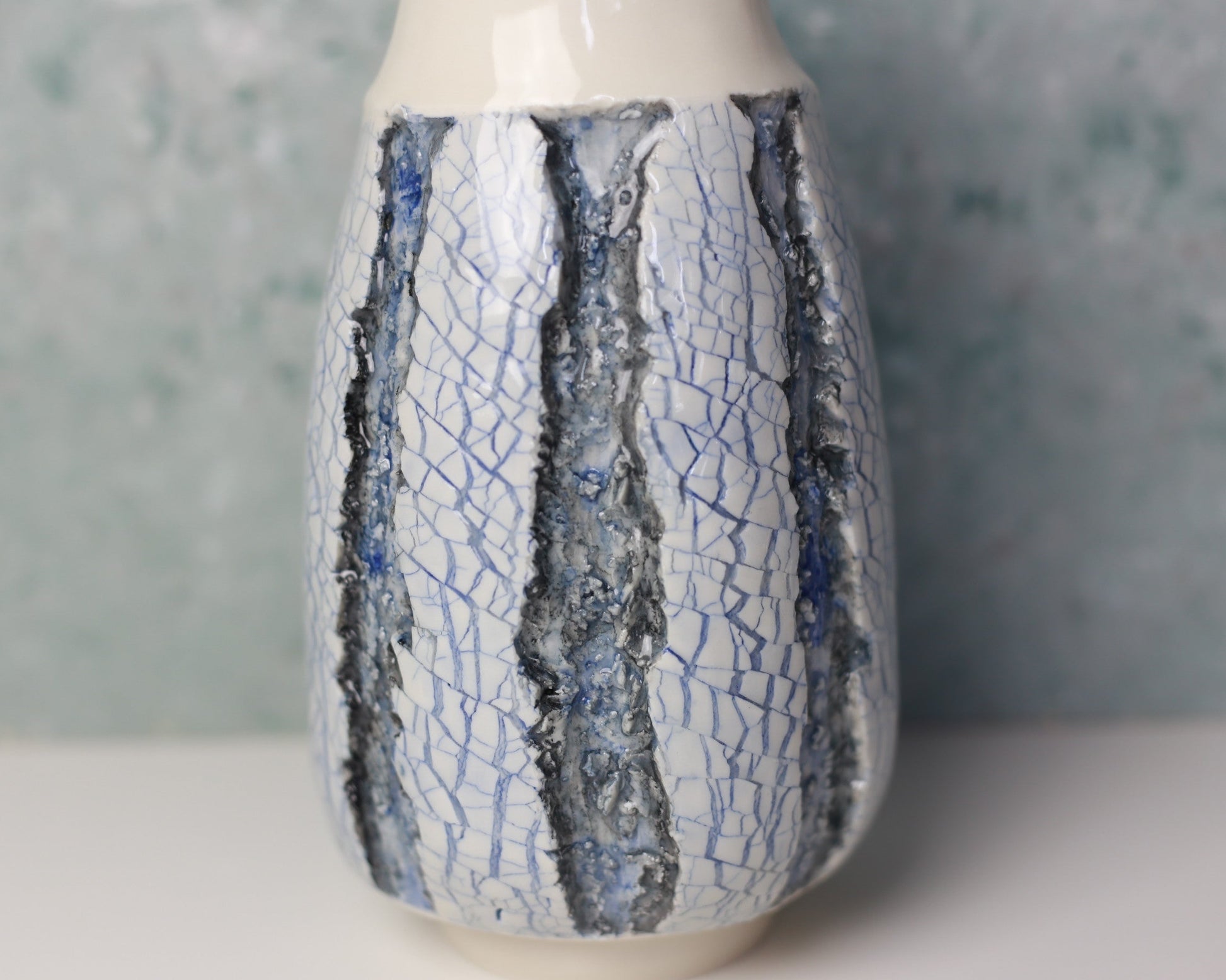 Ceramic vase with crackle glaze pattern on a neutral background