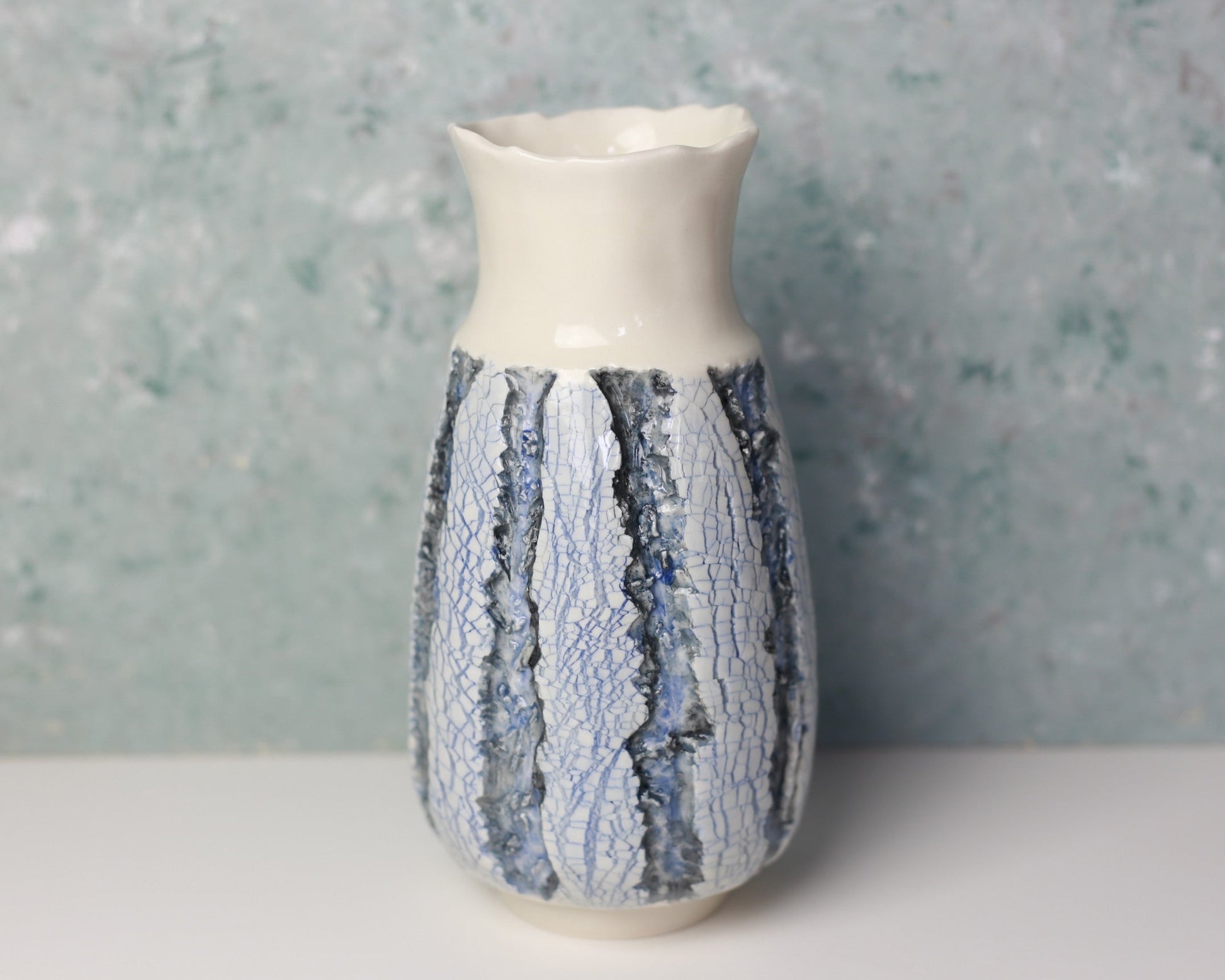 Ceramic vase with textured design on a neutral background