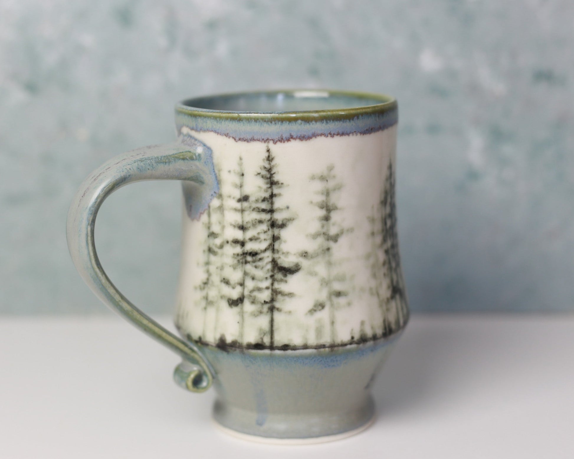 Ceramic mug with a tree pattern on a gray background