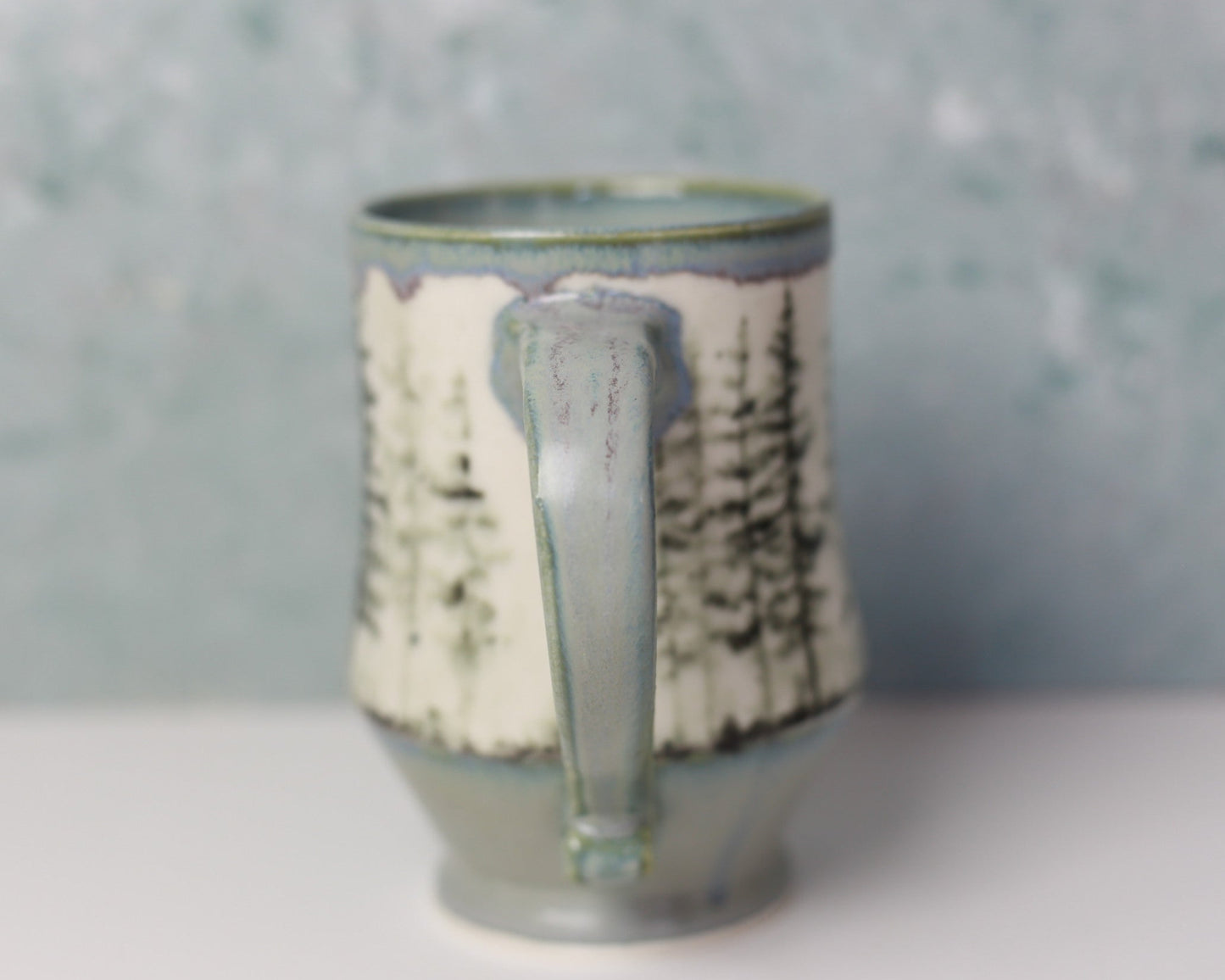 Ceramic mug with text pattern on a gray background