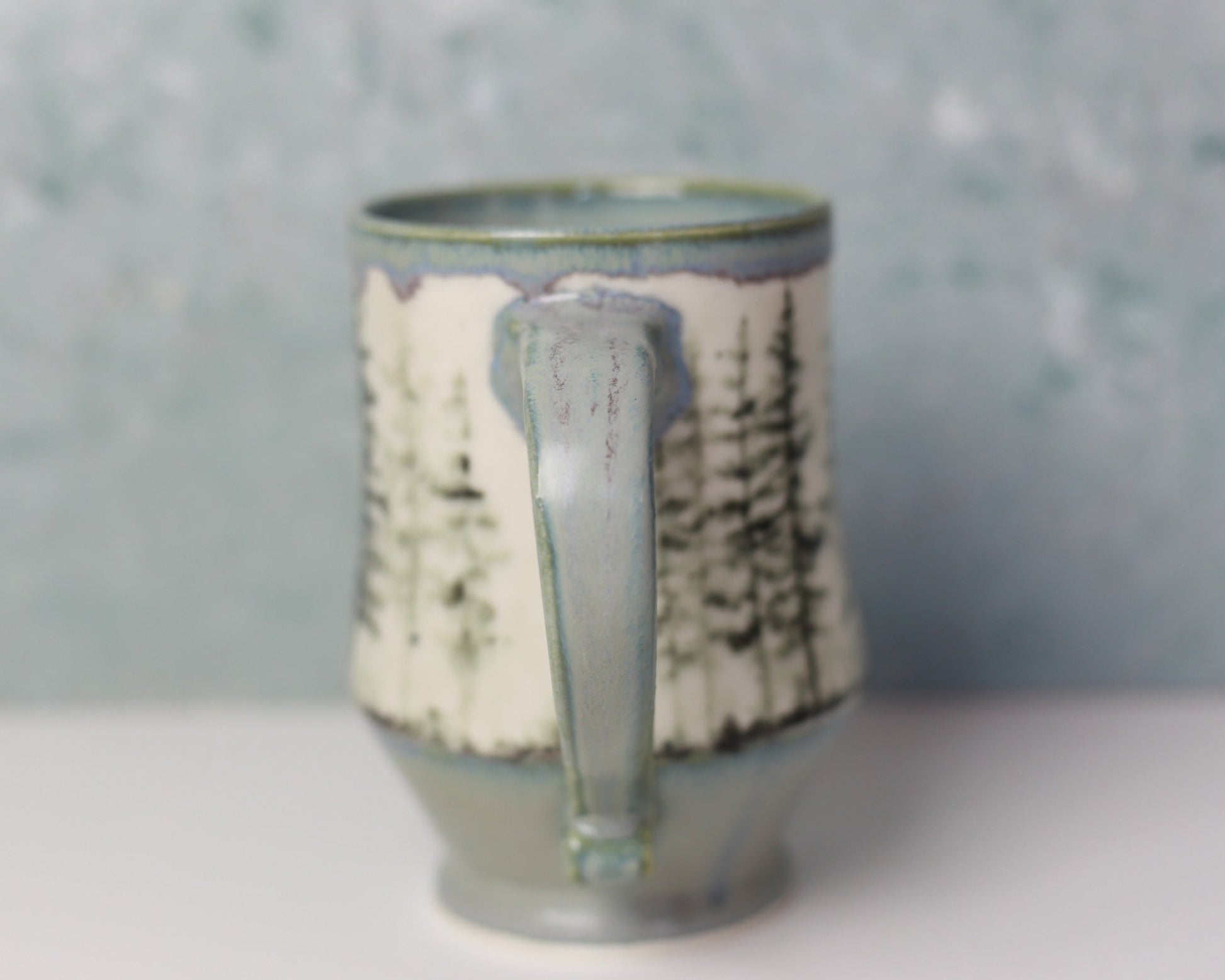 Ceramic mug with text pattern on a gray background