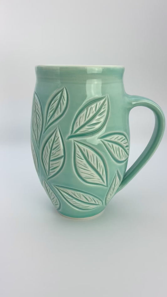 Large porcelain mug with leaf carvings in turquoise